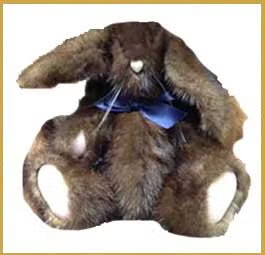 Brown plush teddy bear with floppy ears and blue ribbon against a white background
