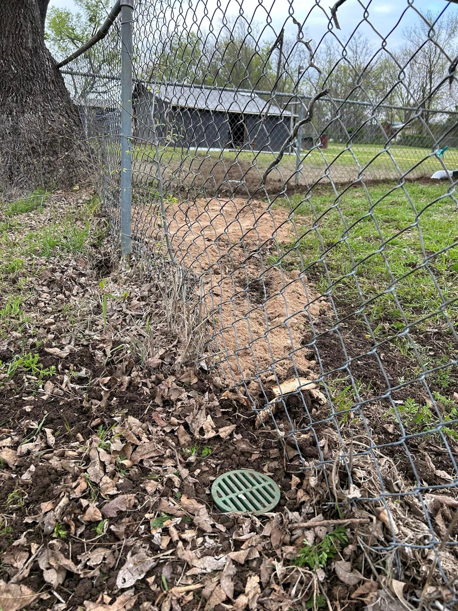 A Chain Link Fence with A Drain in The Middle of It - Collinsville, TX - L5 Irrigation