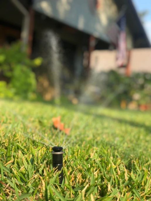 A Lawn Sprinkler Is Spraying Water on A Lush Green Lawn - Collinsville, TX - L5 Irrigation