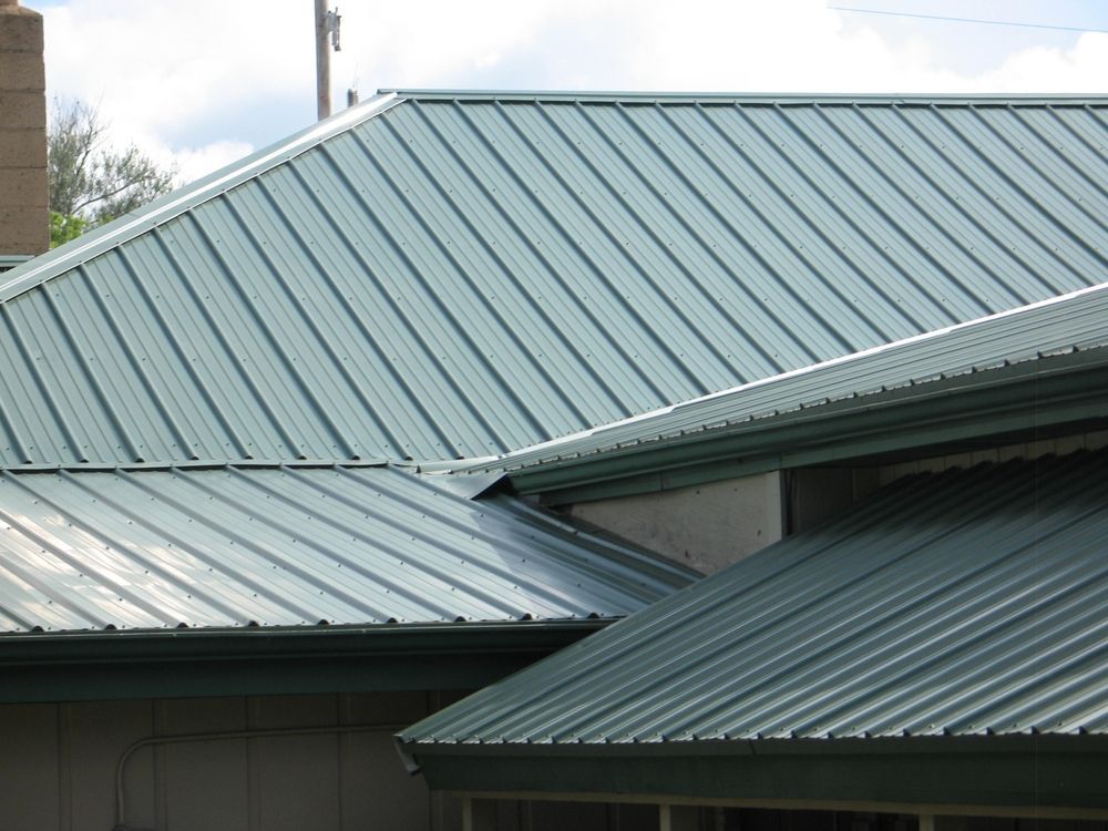 A close up of a green metal roof on a house