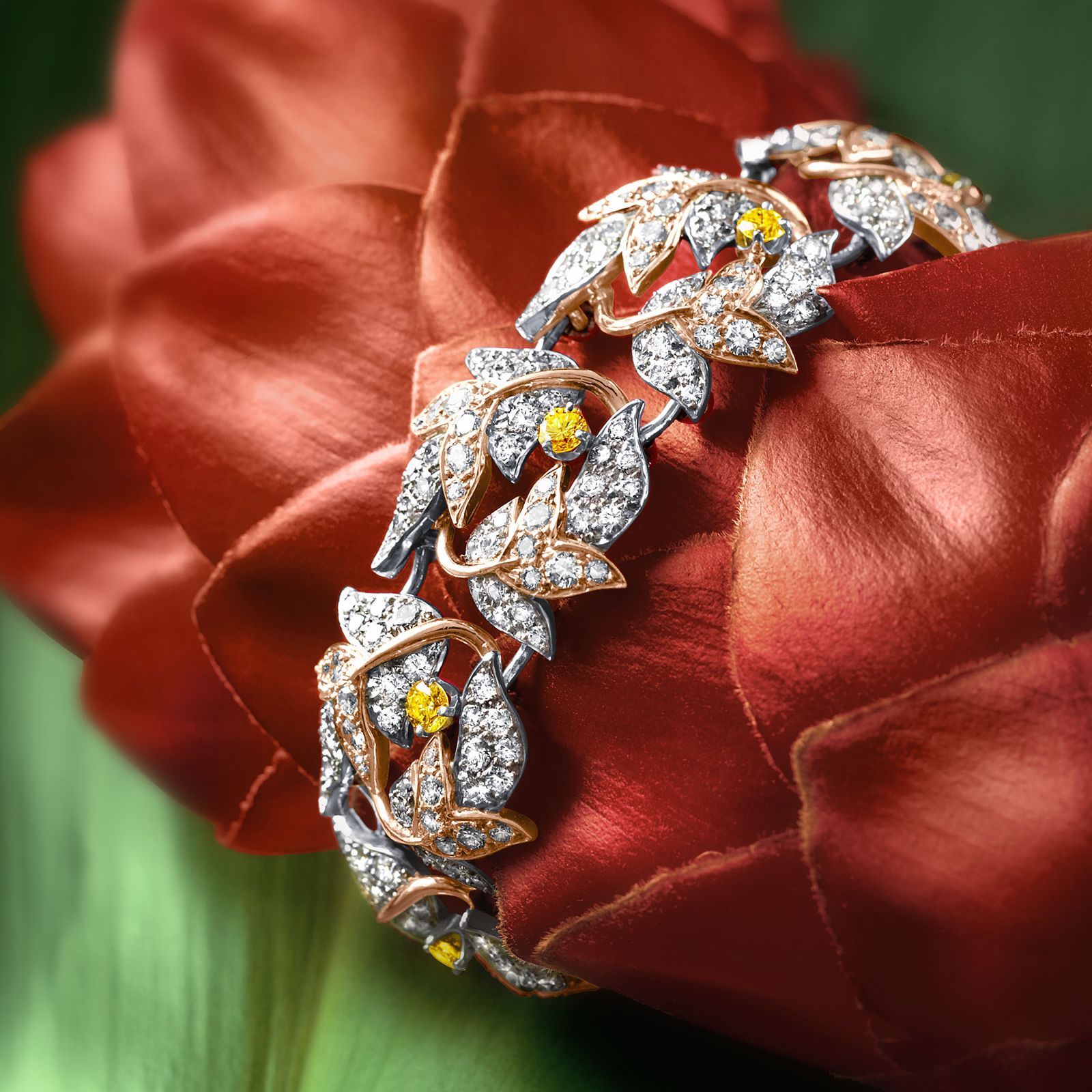 A gold ring with purple and red stones and diamonds