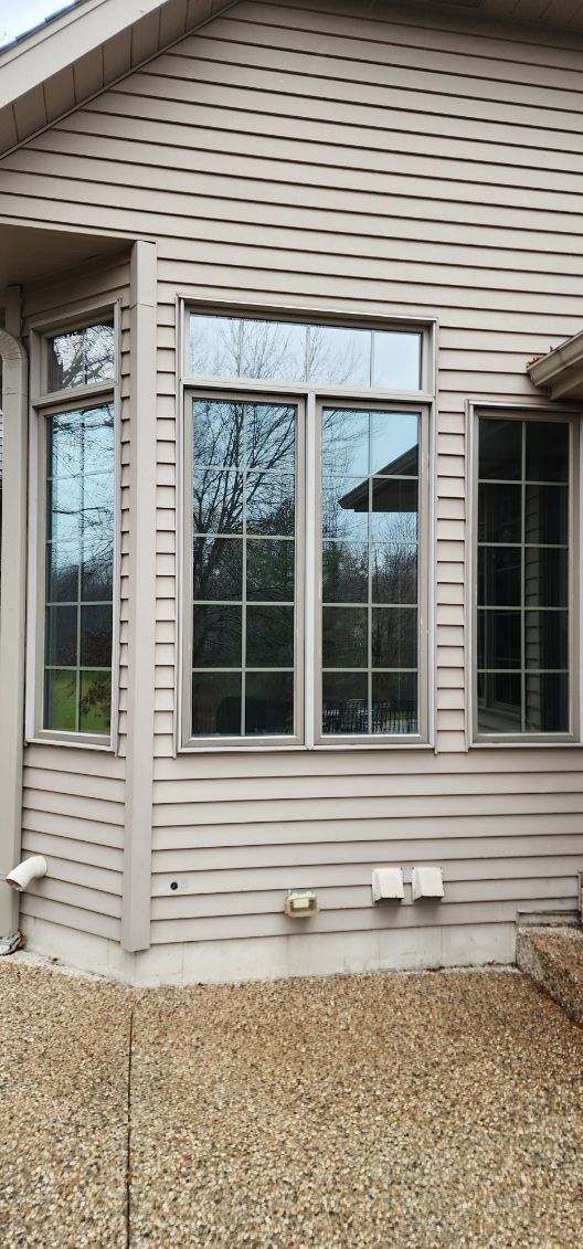 House exterior with tan siding, bay window, and gravel landscaping