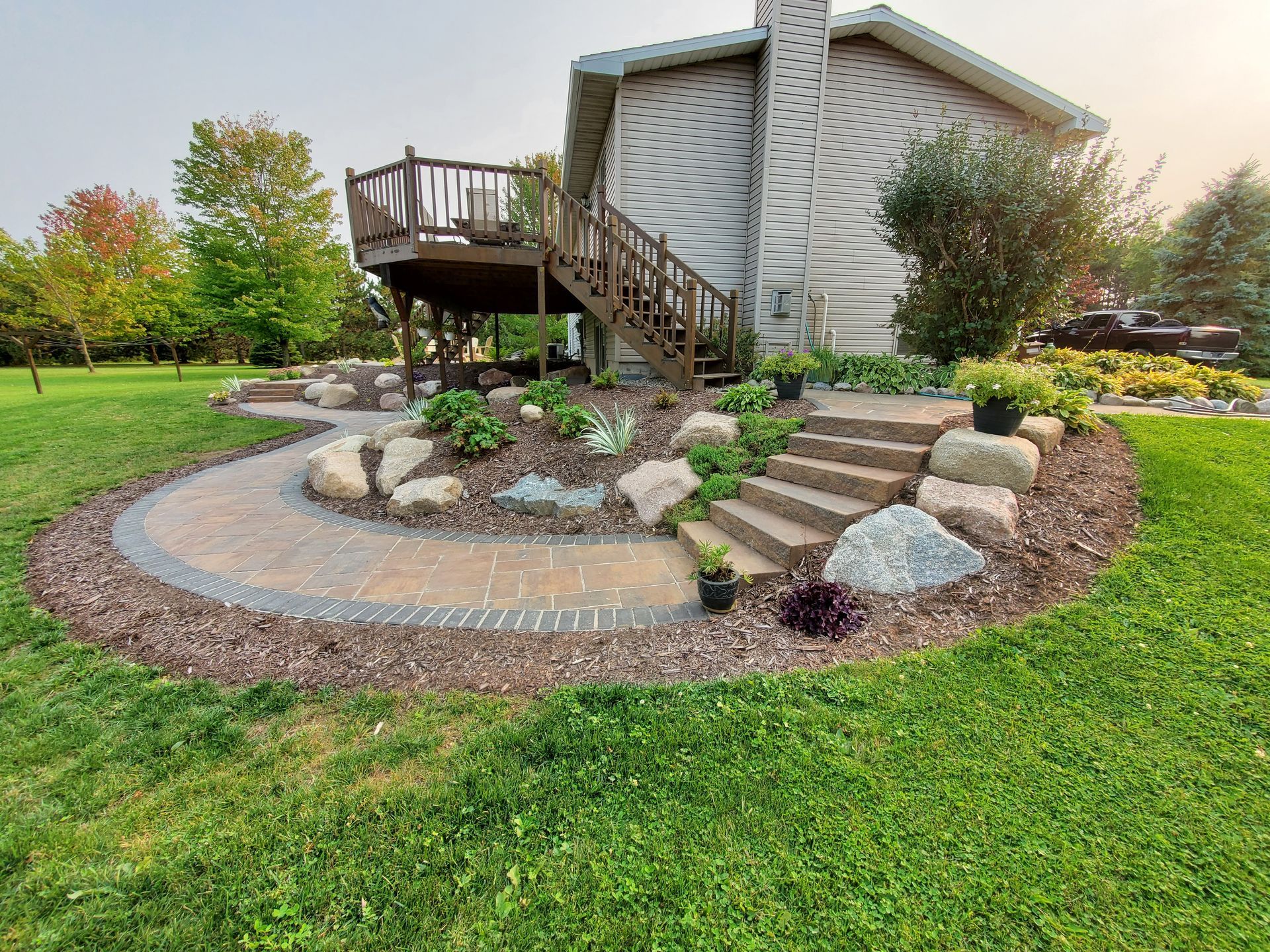 A house with a deck and stairs in the backyard.
