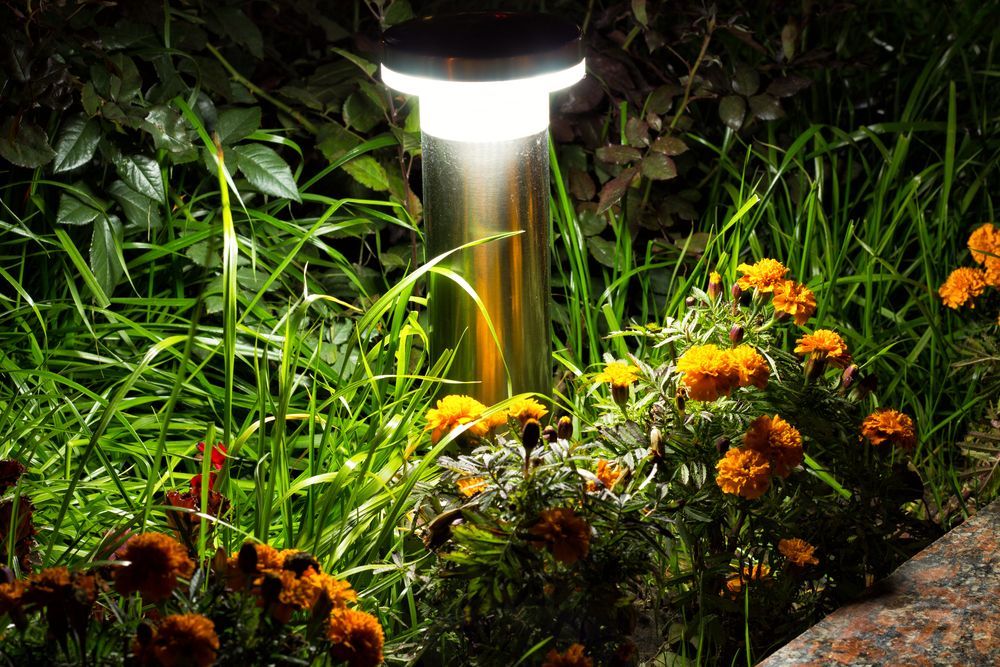 A garden with flowers and a light in the middle of it in Rothschild, Wisconsin