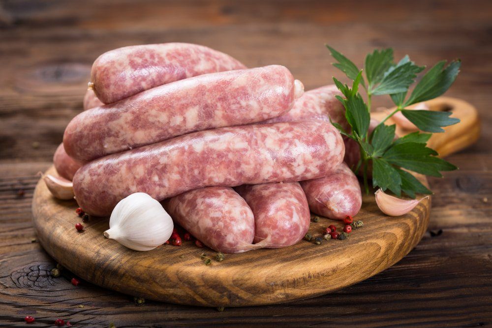 Raw Sausages On The Wooden Board — Butcher in Wauchope, NSW