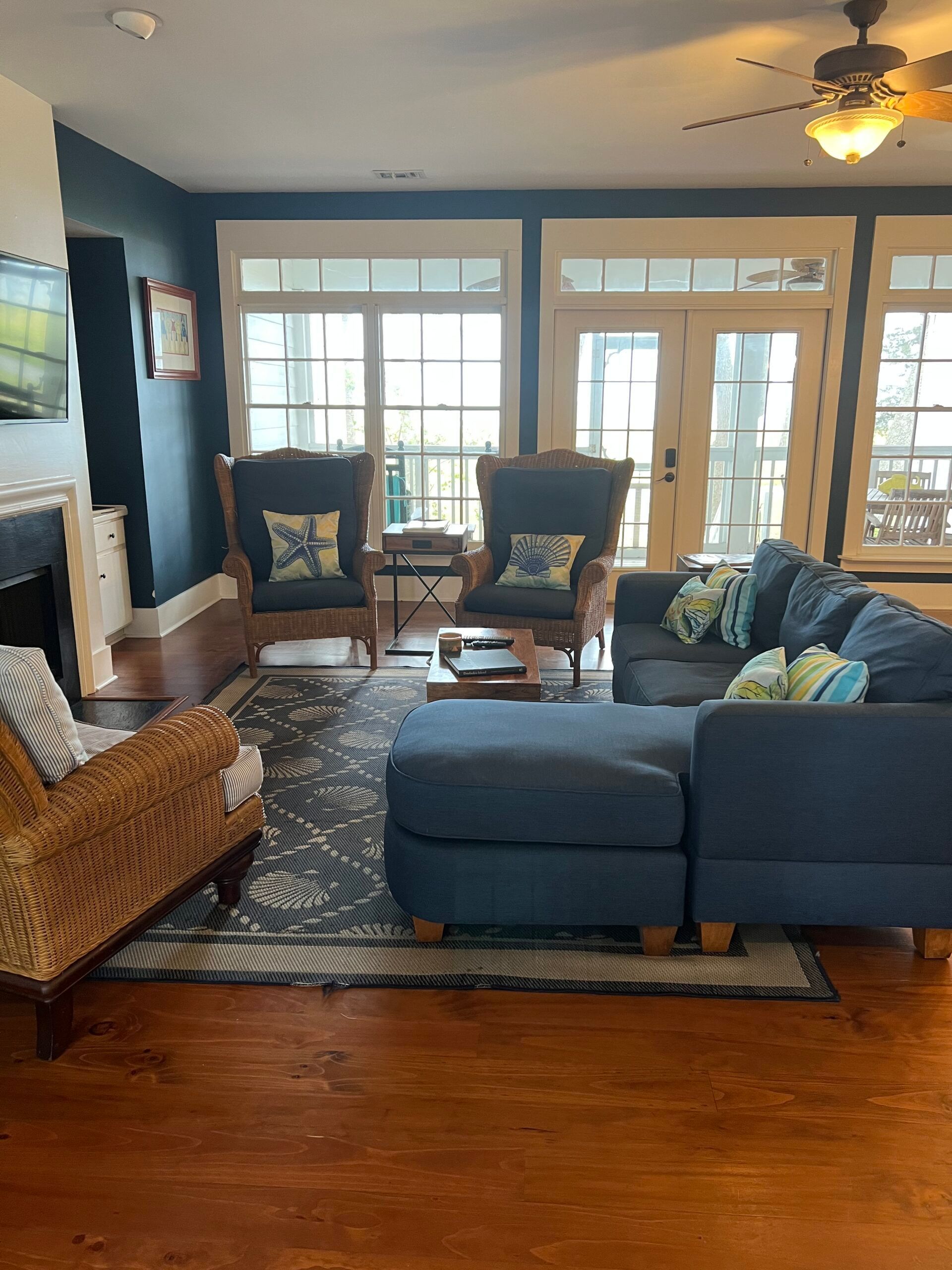 A living room filled with furniture and a ceiling fan.
