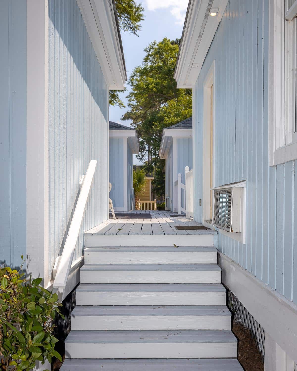A blue house with white stairs leading up to it