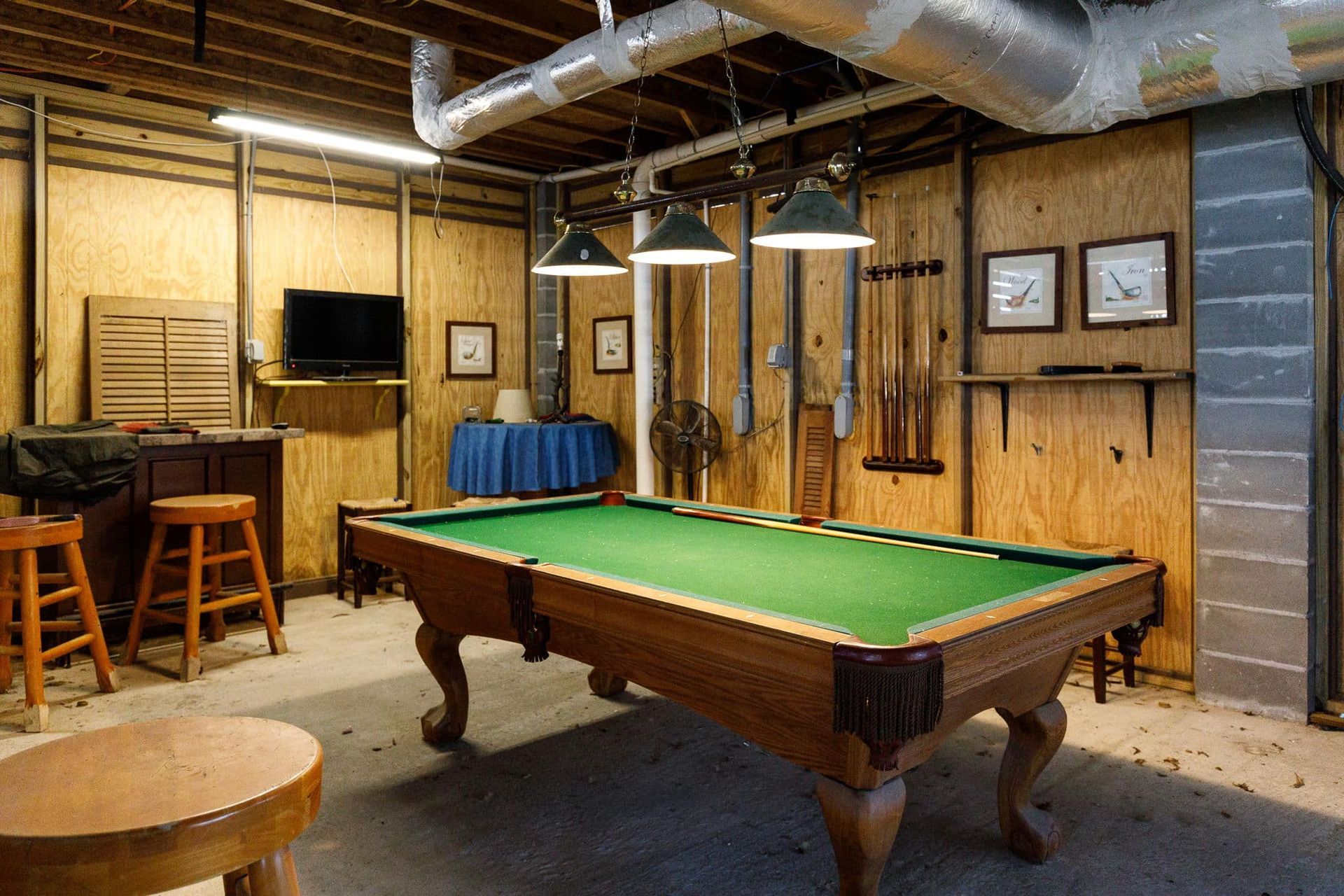 There is a pool table in the middle of the room.