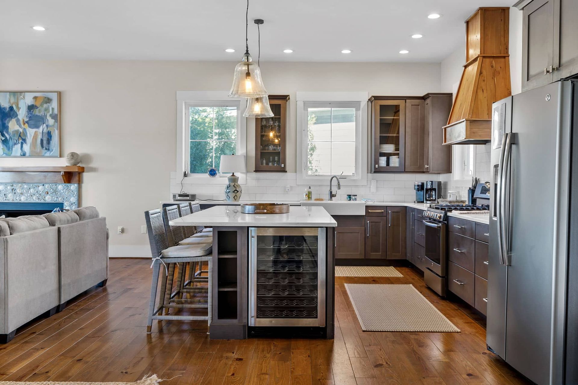 A kitchen with stainless steel appliances and a wine cooler.