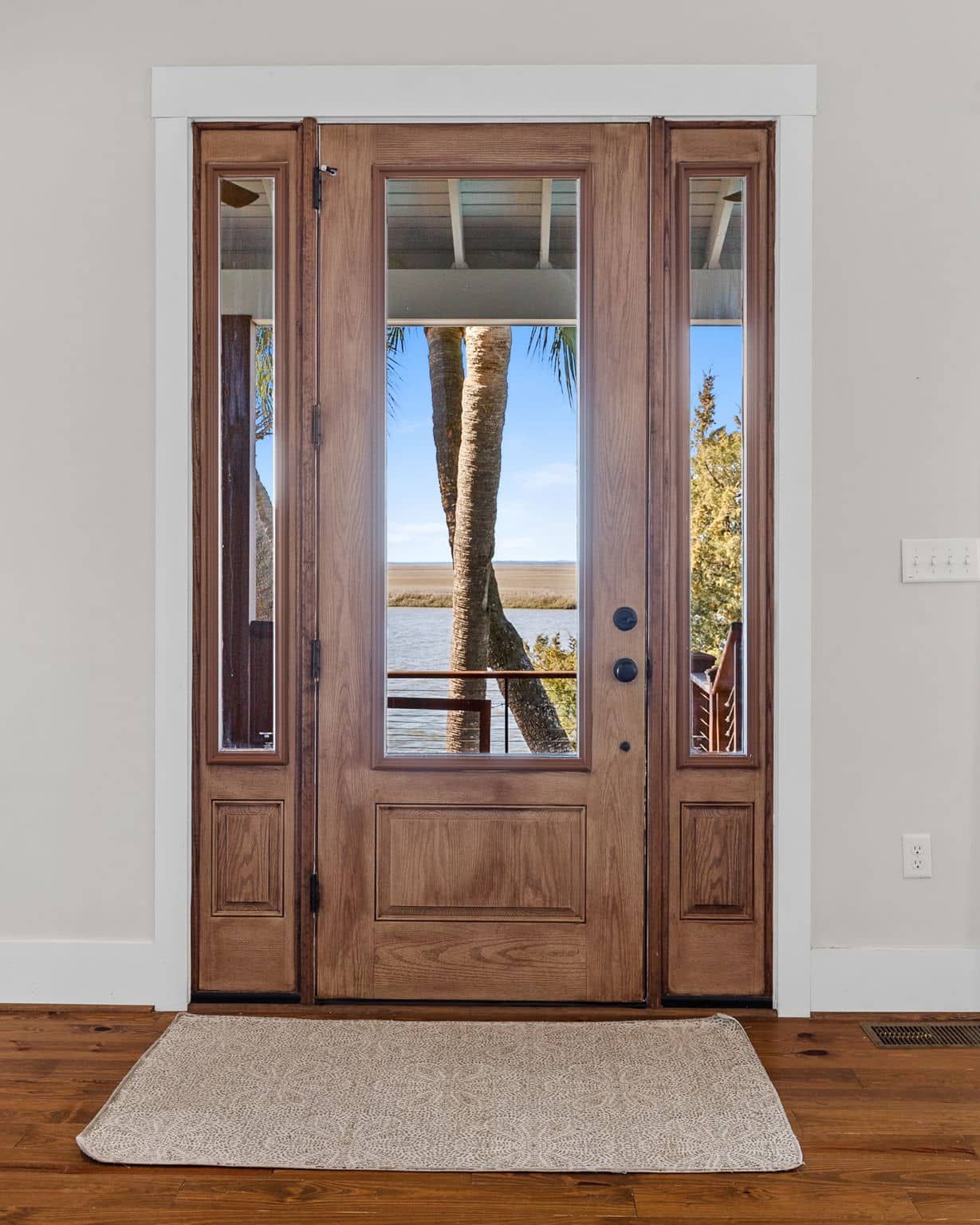 A wooden door with a view of a lake