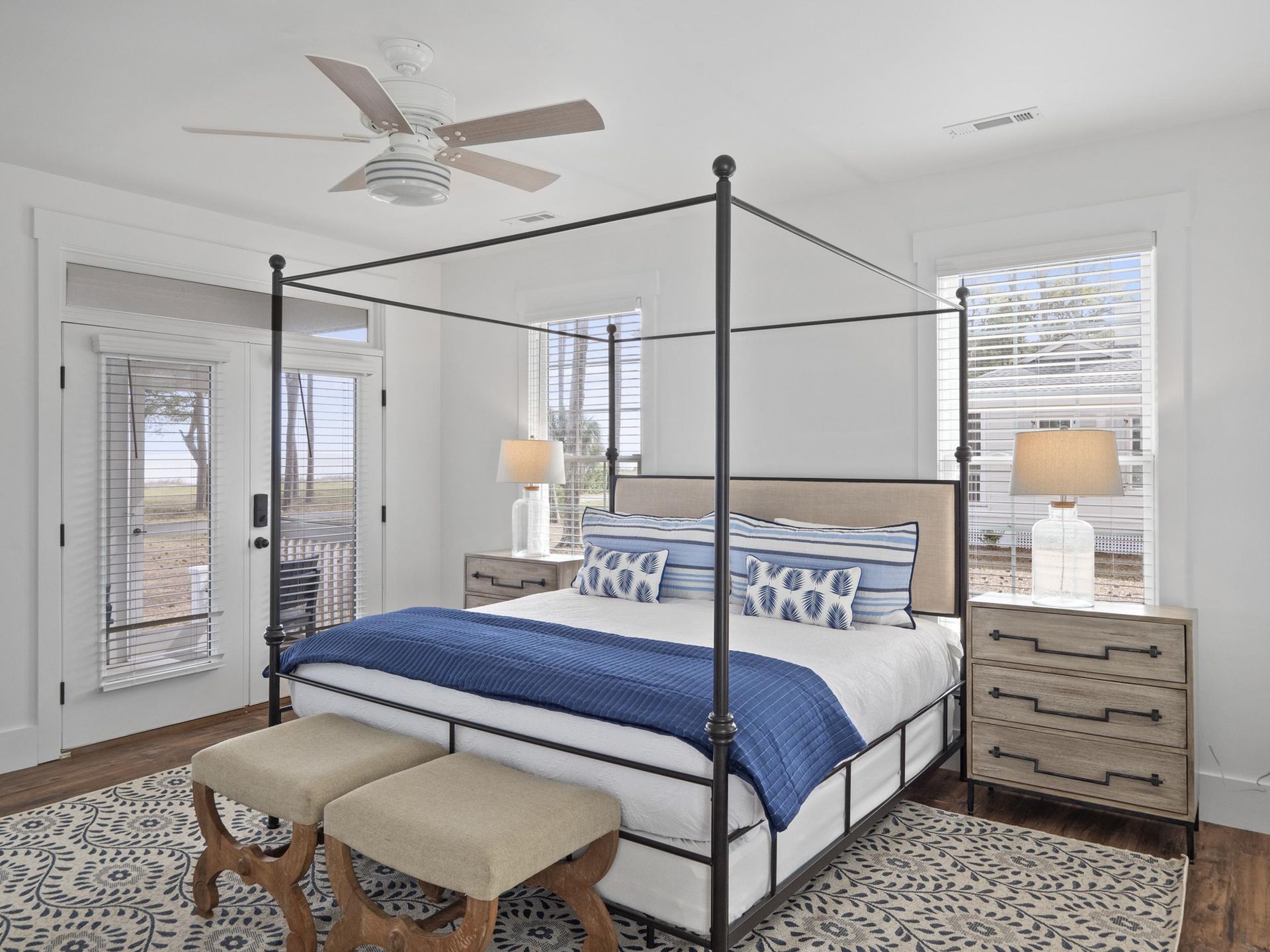 A bedroom with a canopy bed and a ceiling fan.
