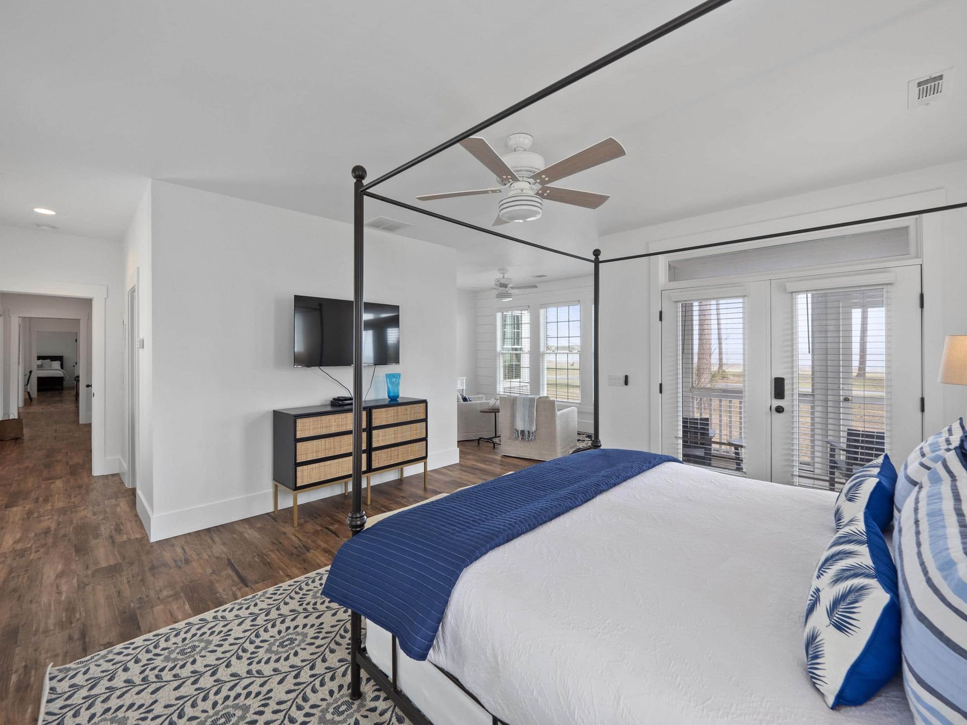 A bedroom with a canopy bed and a flat screen tv.