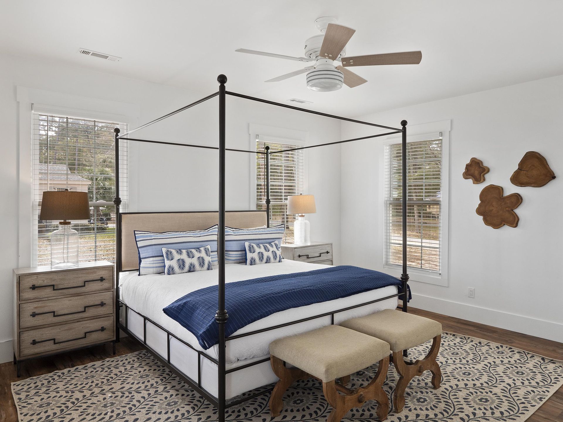 A bedroom with a canopy bed and a ceiling fan.