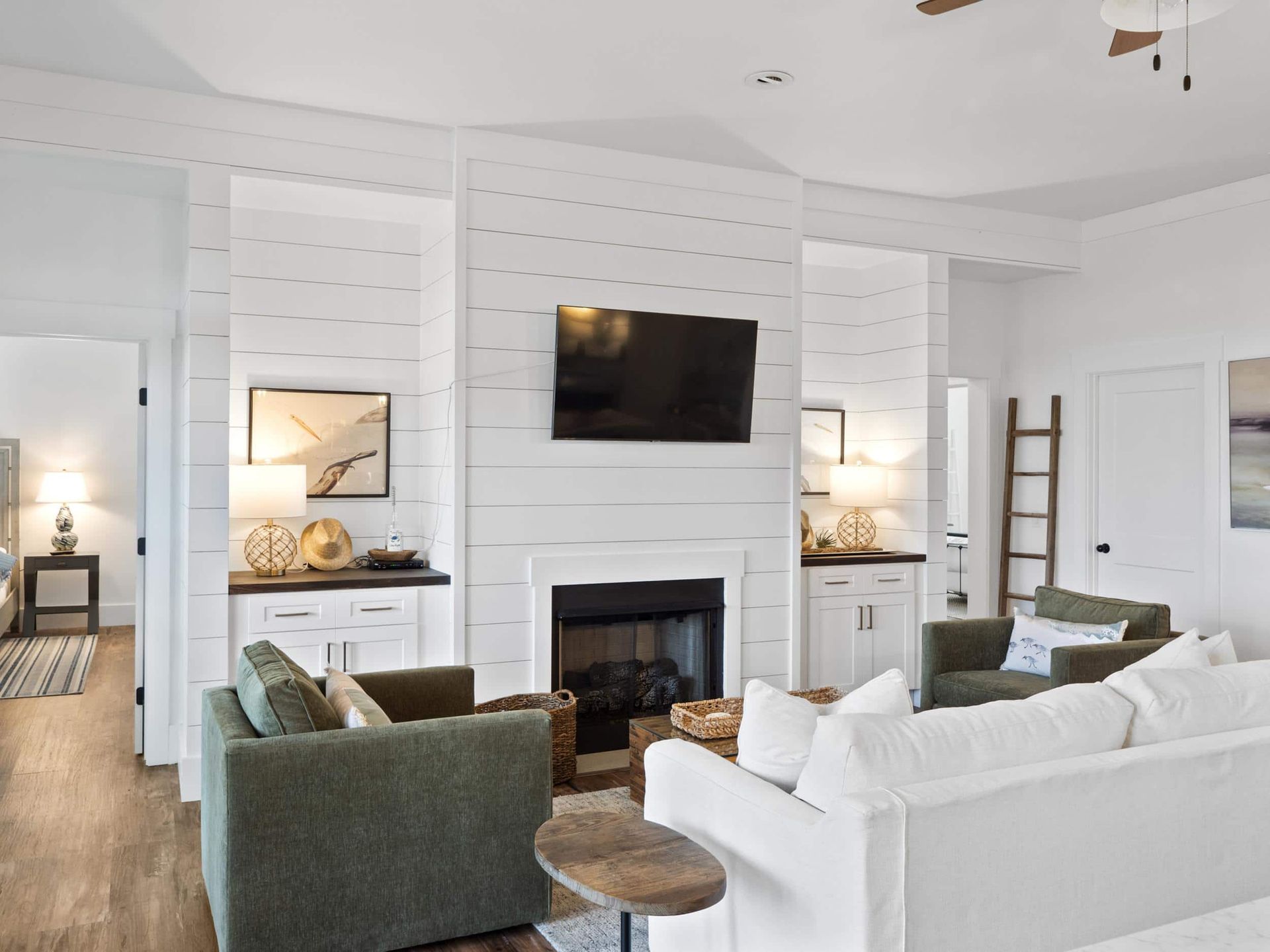 A living room with a fireplace and a flat screen tv