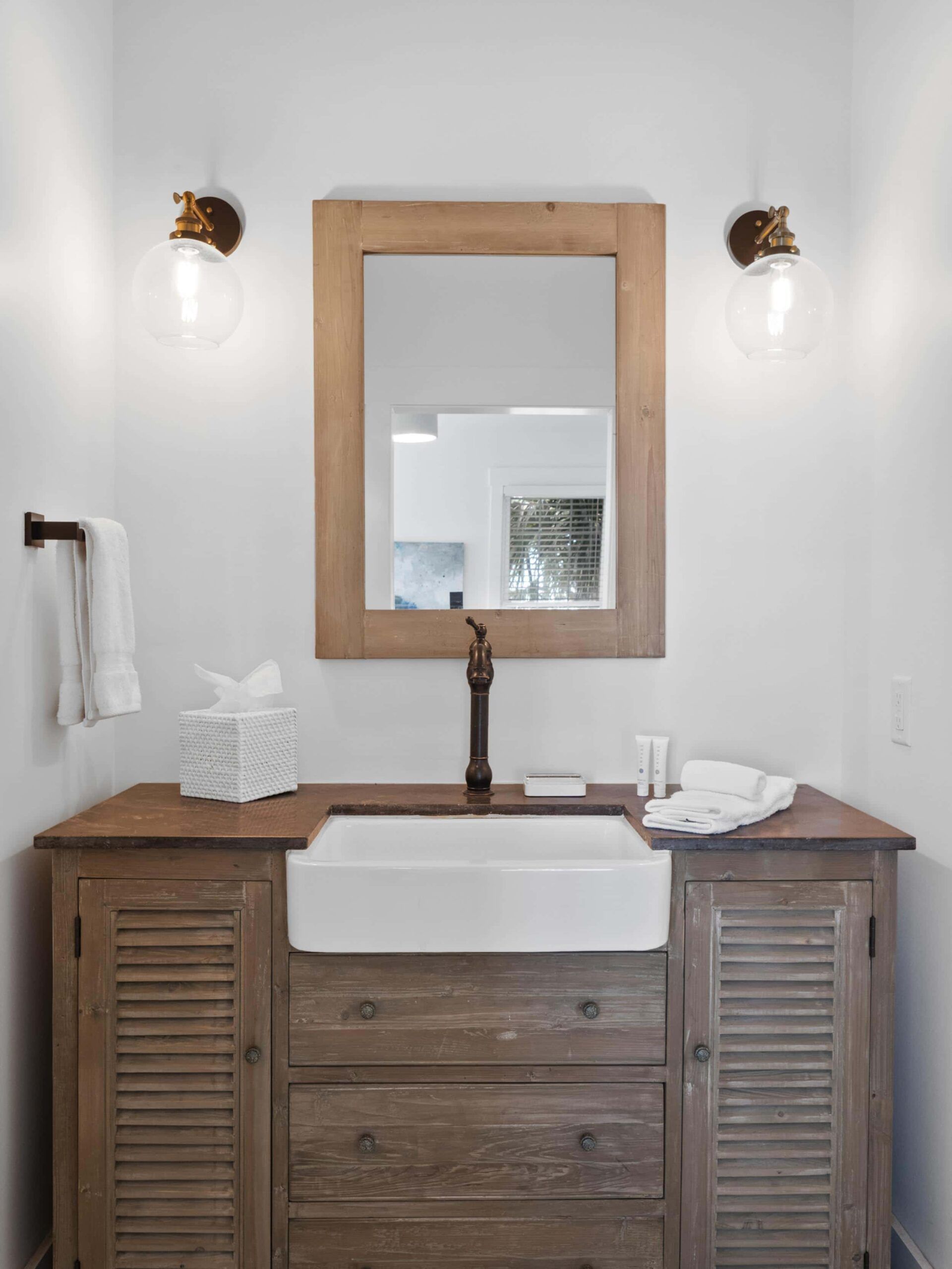 A bathroom with a sink , mirror and cabinets