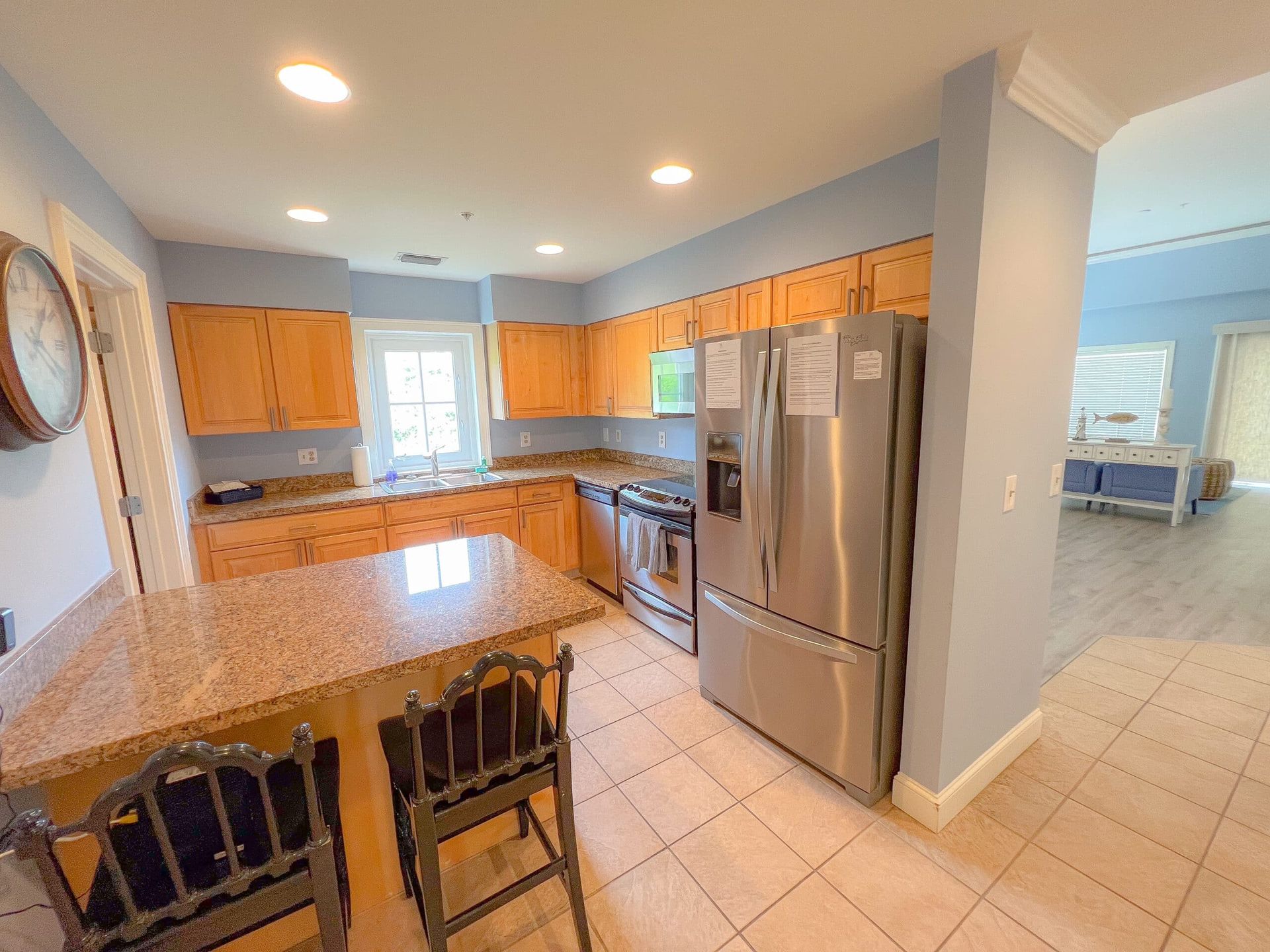 A kitchen with stainless steel appliances and granite counter tops.