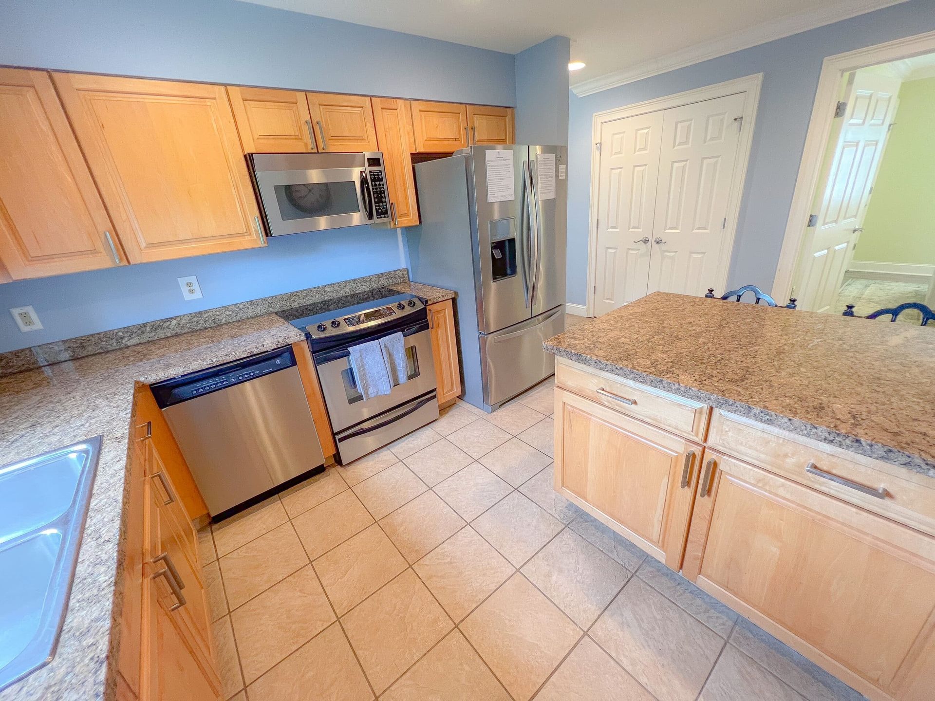 A kitchen with stainless steel appliances and granite counter tops