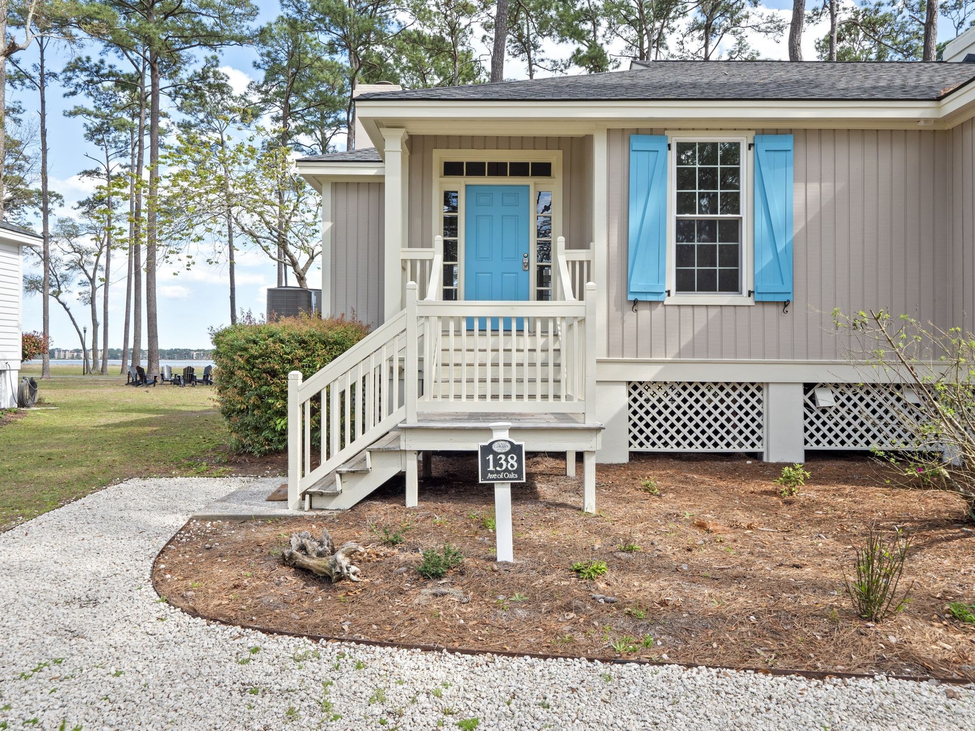 A small house with a blue door and blue shutters.