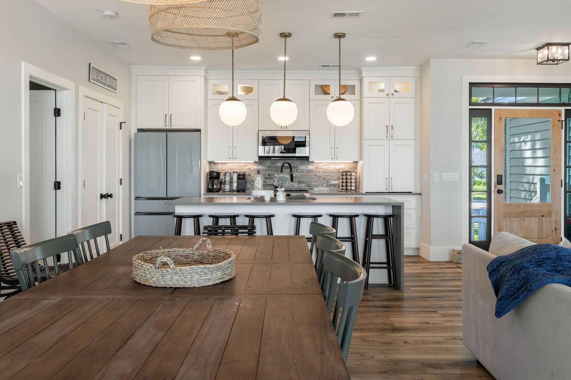 A kitchen and dining room in a house with a wooden table and chairs.