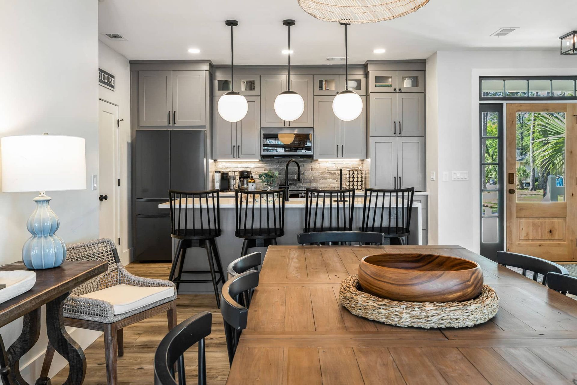 A kitchen and dining room in a house with a wooden table and chairs.