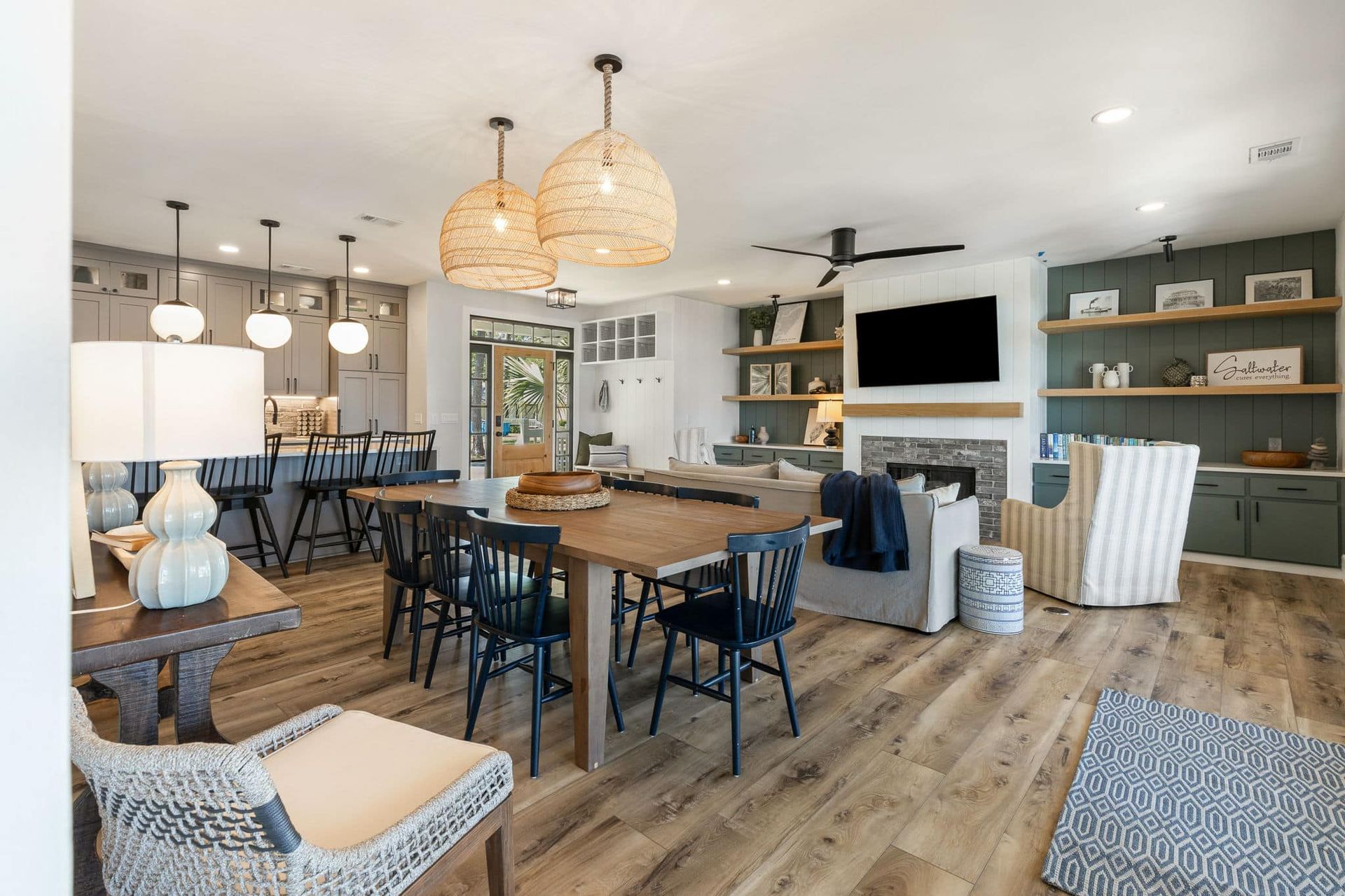A living room with a table , chairs , and a television.