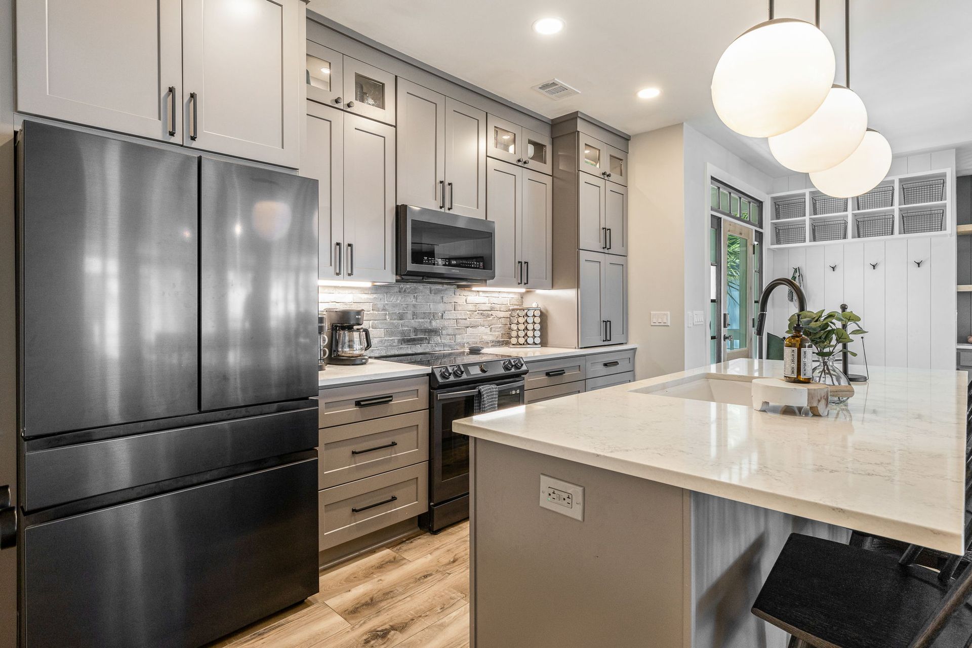 A kitchen with stainless steel appliances and white cabinets.
