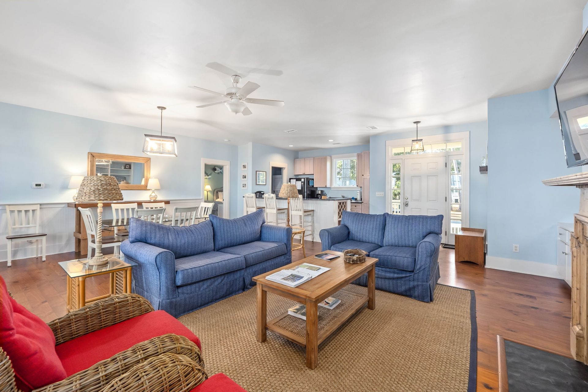 A living room filled with furniture and a ceiling fan.
