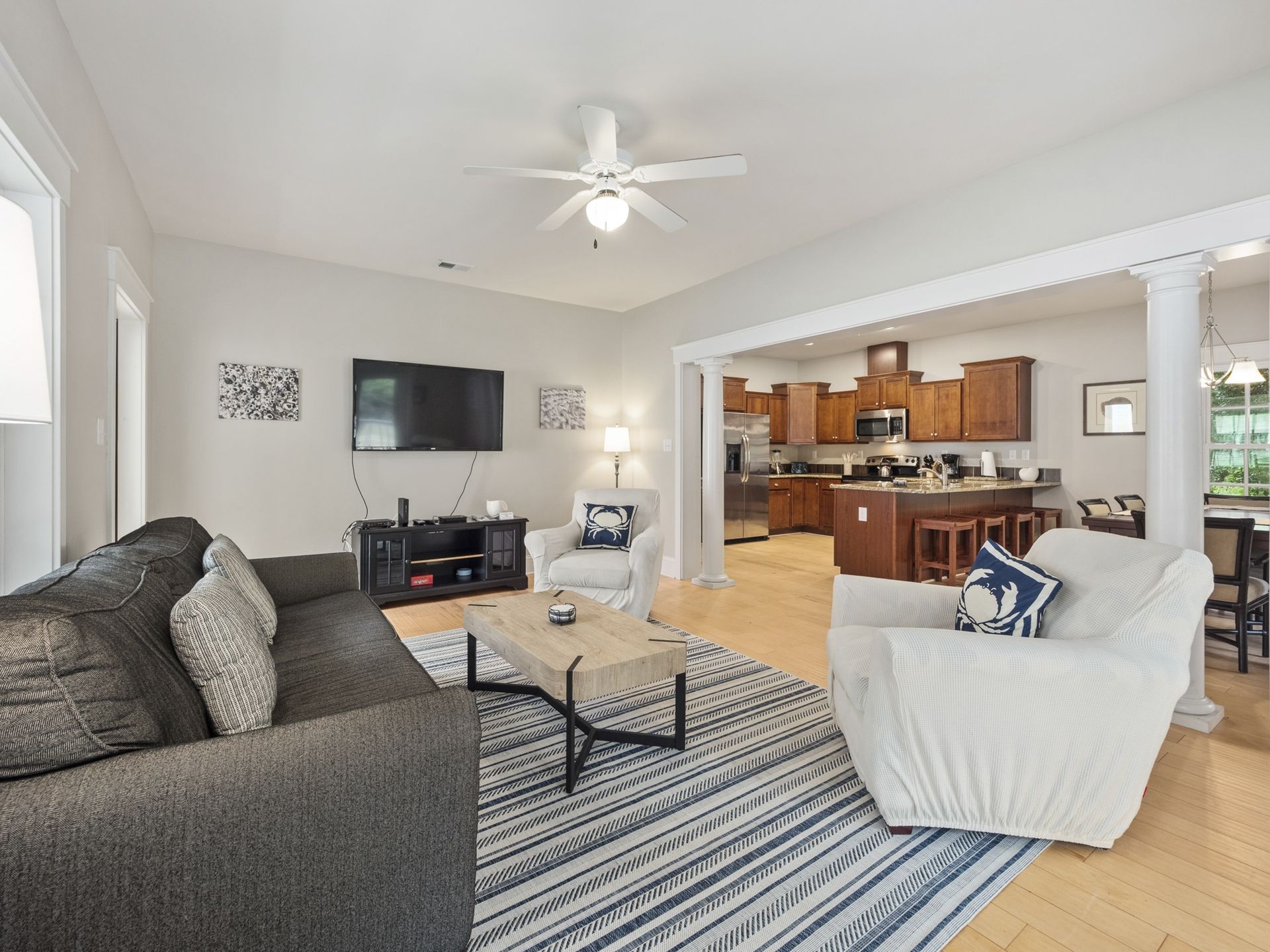 A living room filled with furniture and a ceiling fan.