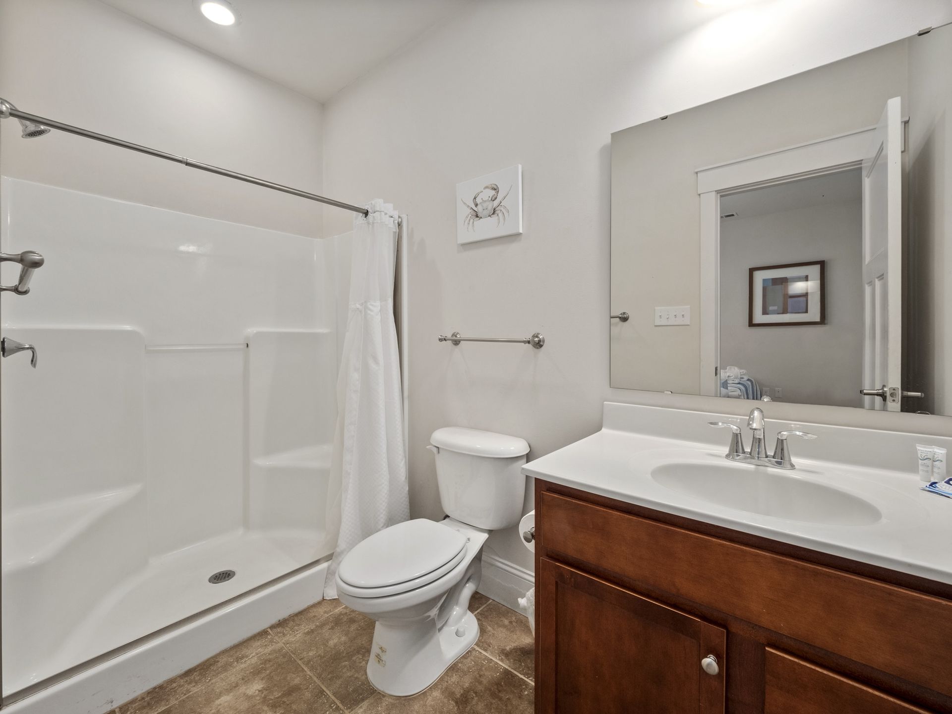 A bathroom with a toilet , sink , and shower.