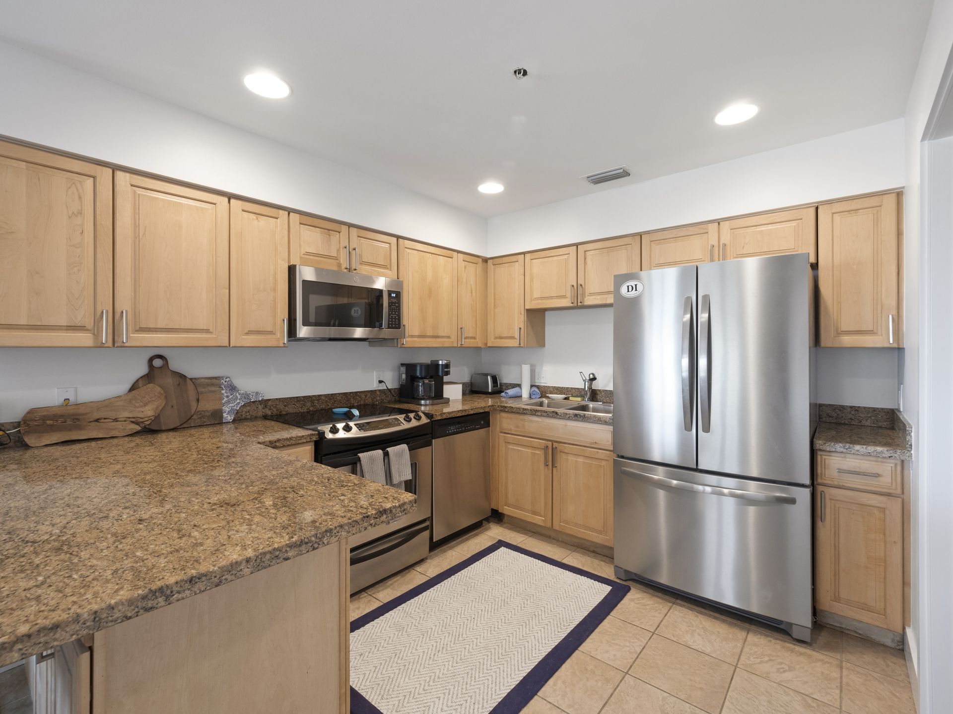 A kitchen with stainless steel appliances and wooden cabinets