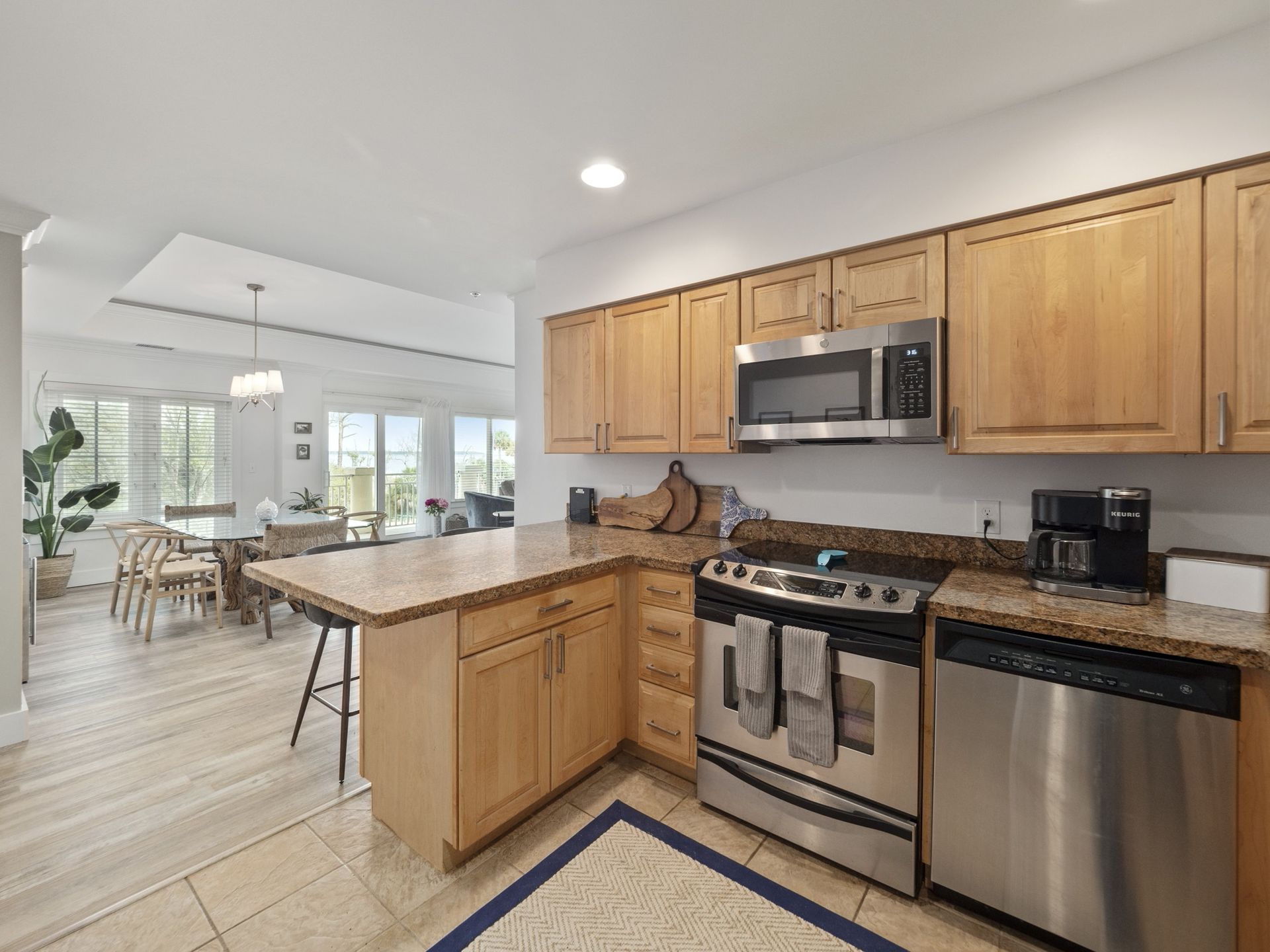 A kitchen with stainless steel appliances and wooden cabinets.