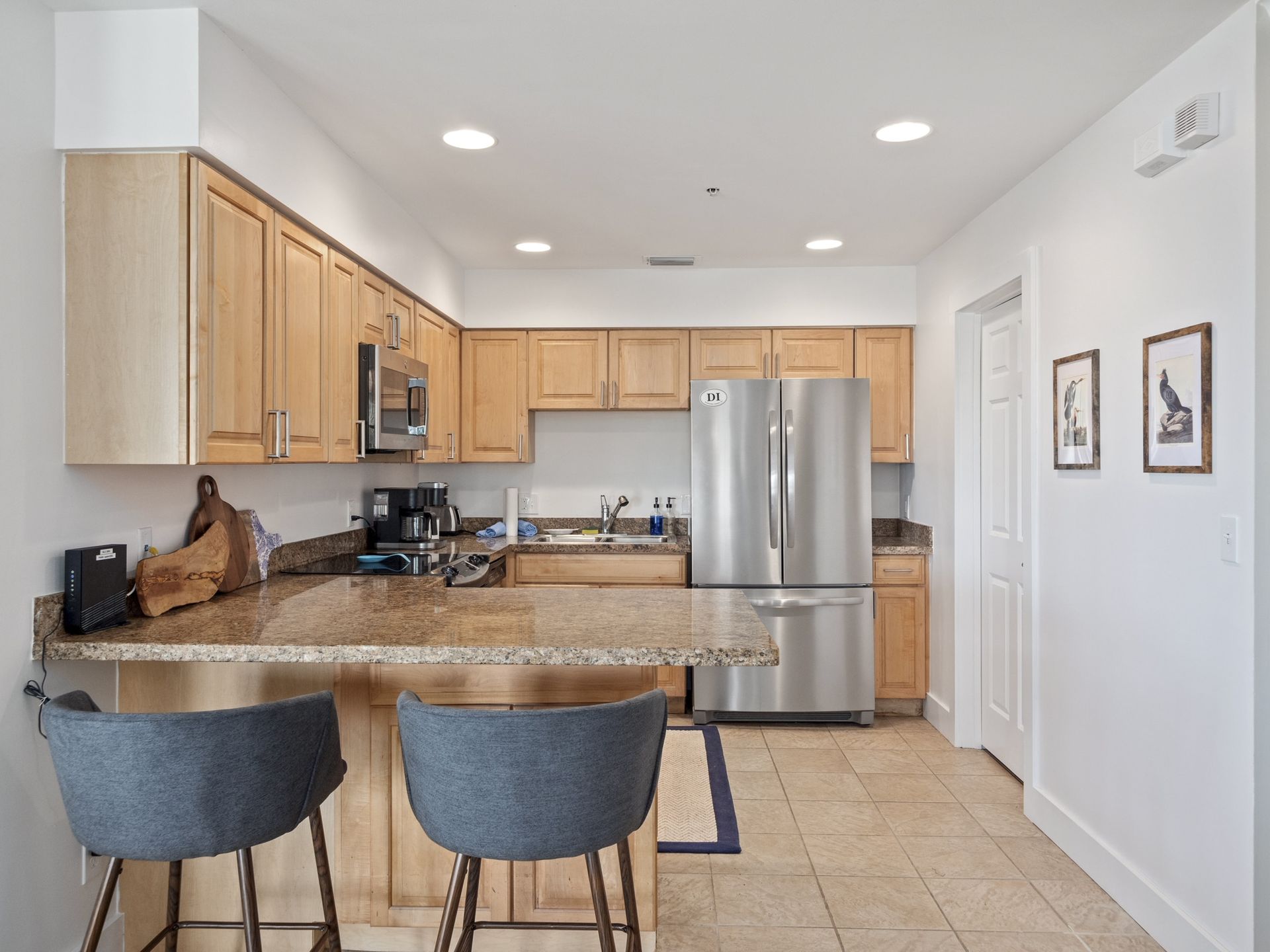 A kitchen with stainless steel appliances and wooden cabinets