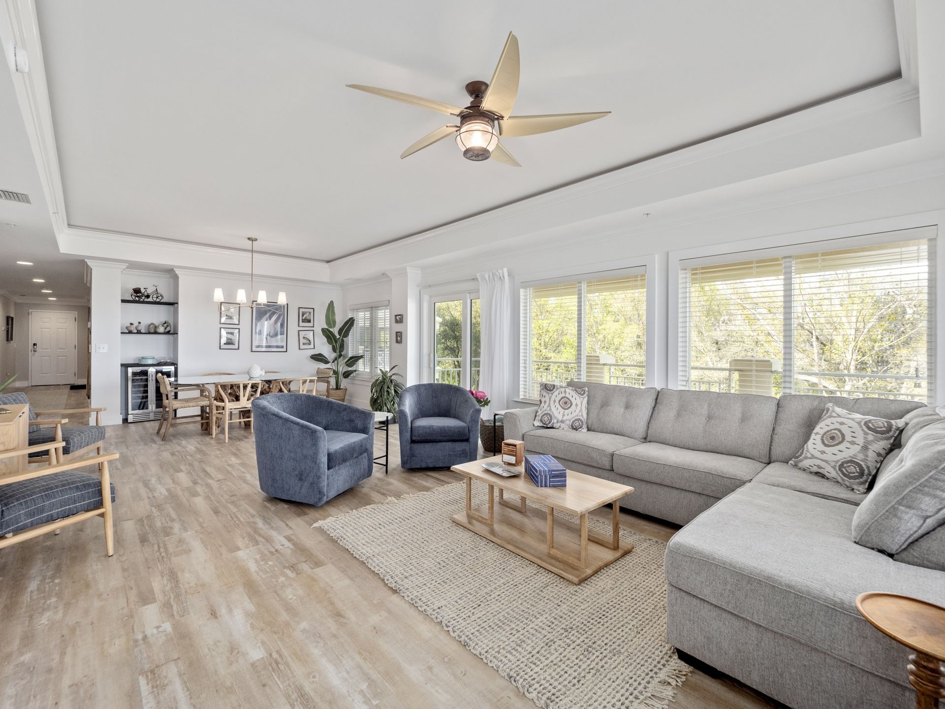 A living room filled with furniture and a ceiling fan.