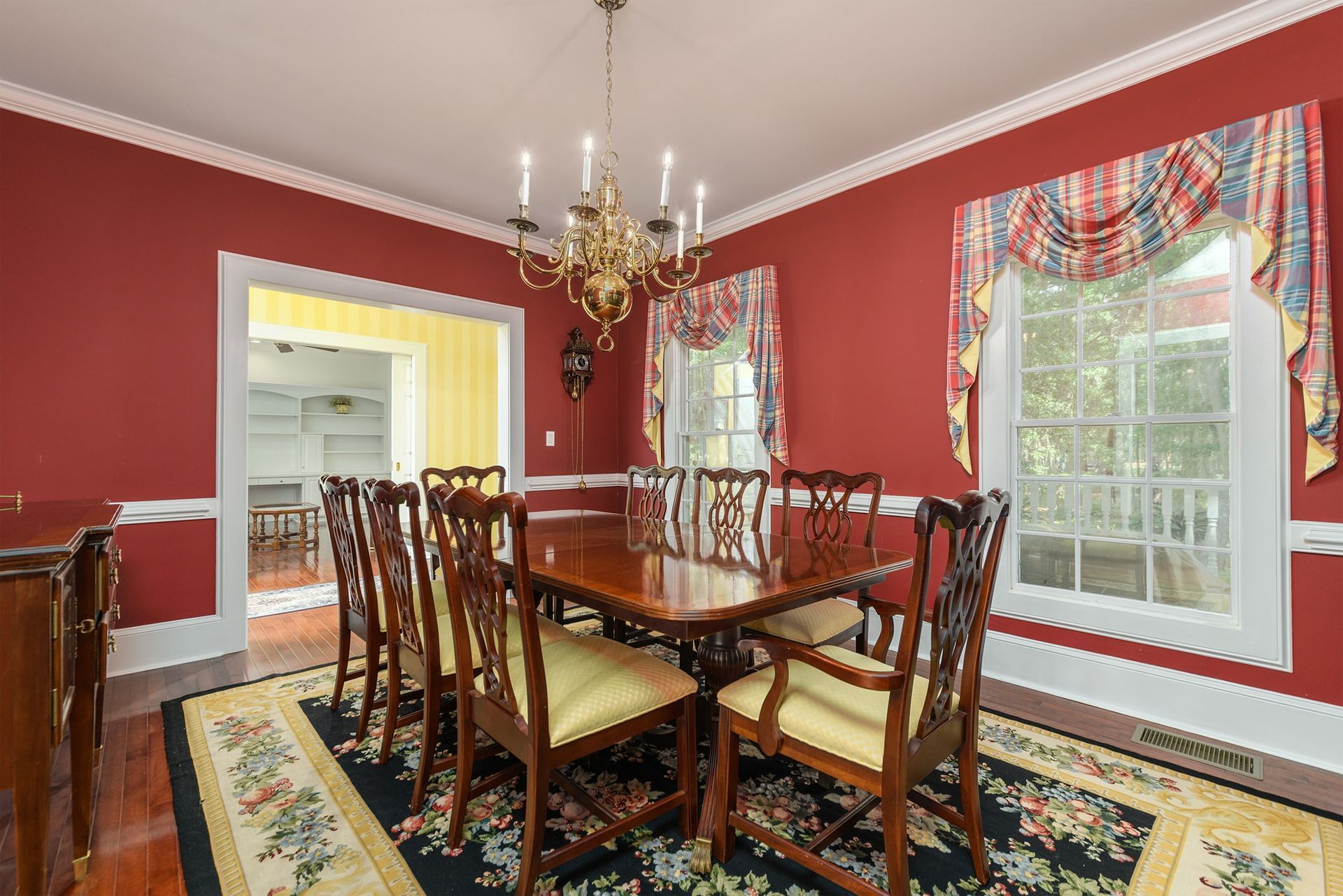 A dining room with a table and chairs and a chandelier.