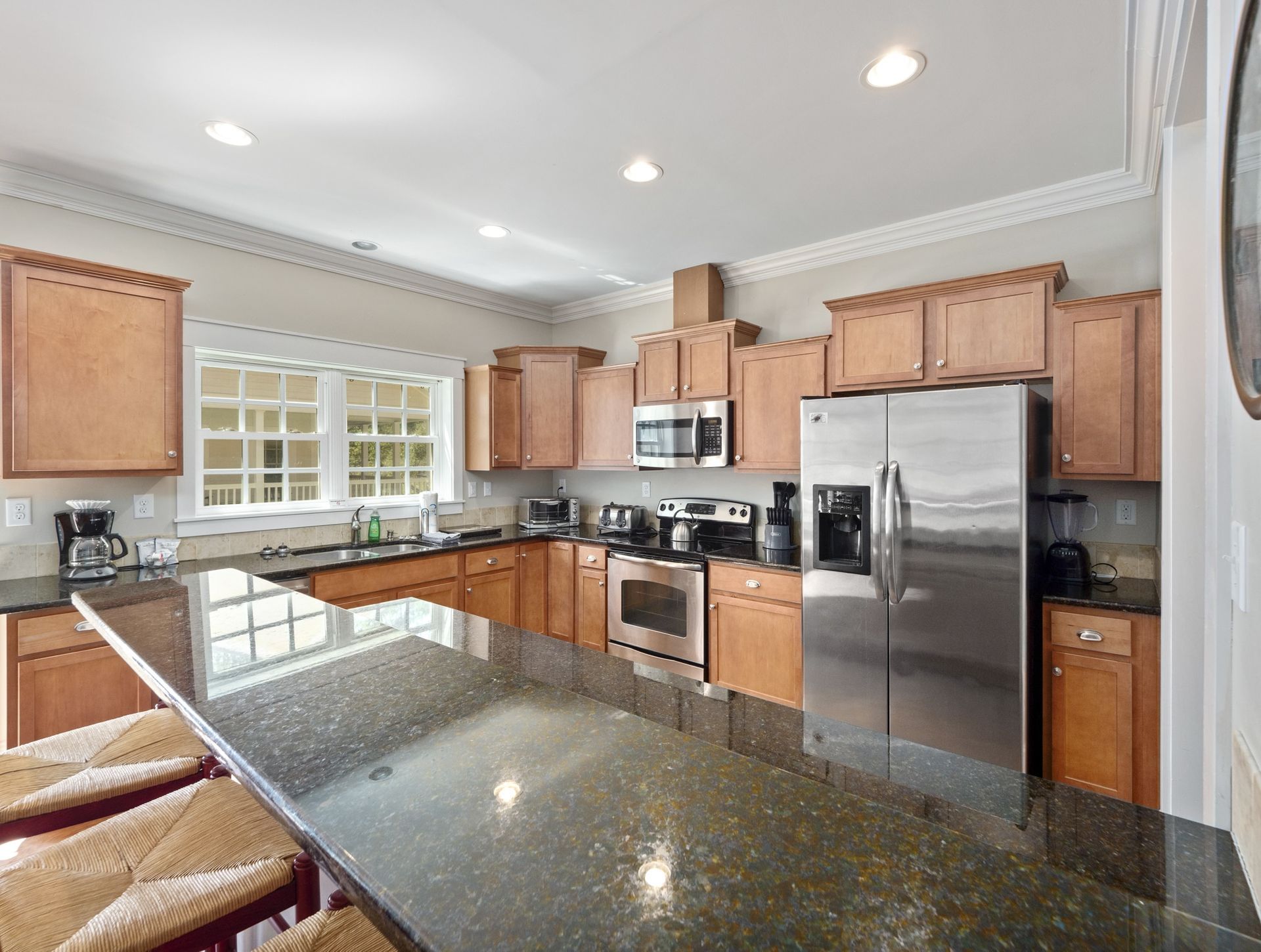 A kitchen with stainless steel appliances and granite counter tops