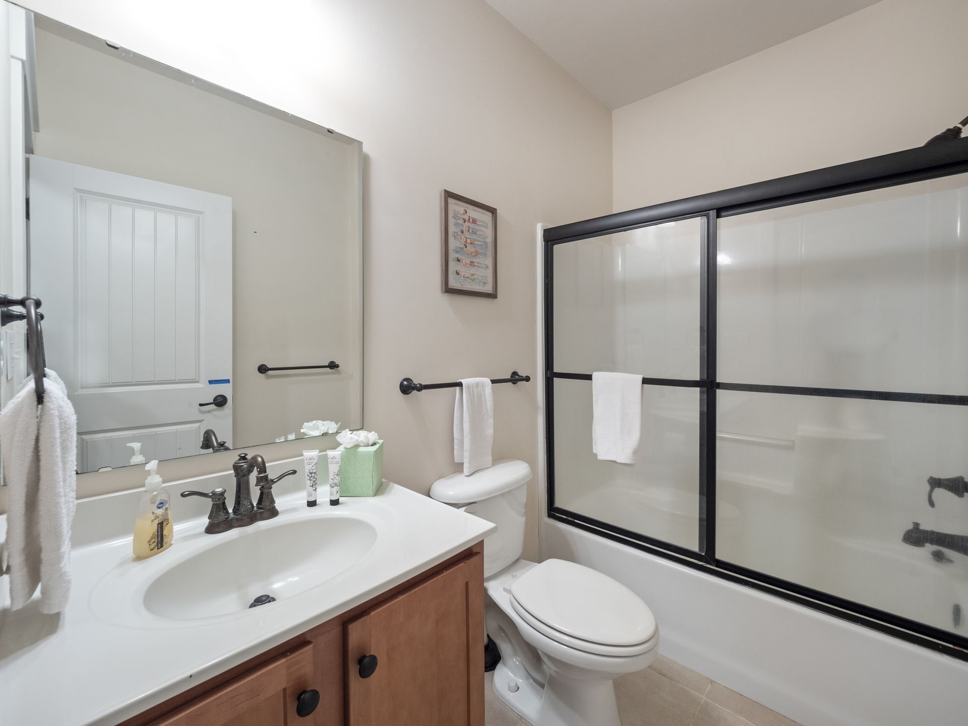 A bathroom with a toilet , sink , and shower.