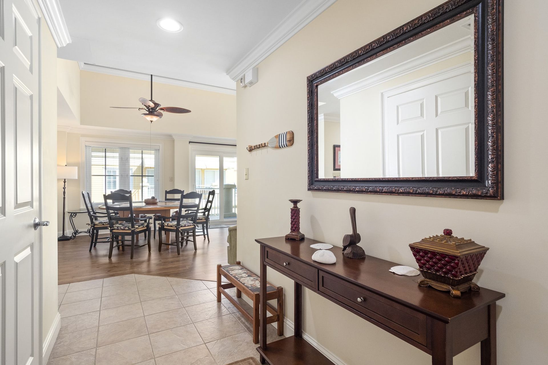 A hallway in a house with a table and a mirror.