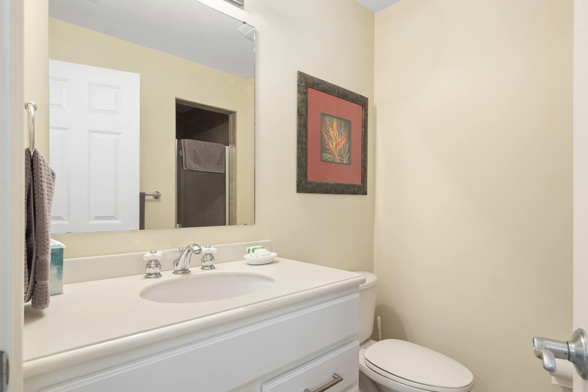 A bathroom with a sink , toilet and mirror.