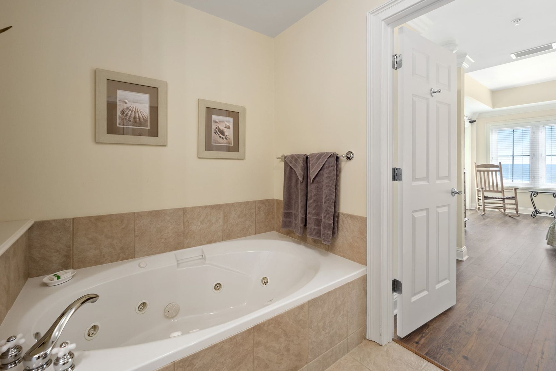 A bathtub in a bathroom next to a door