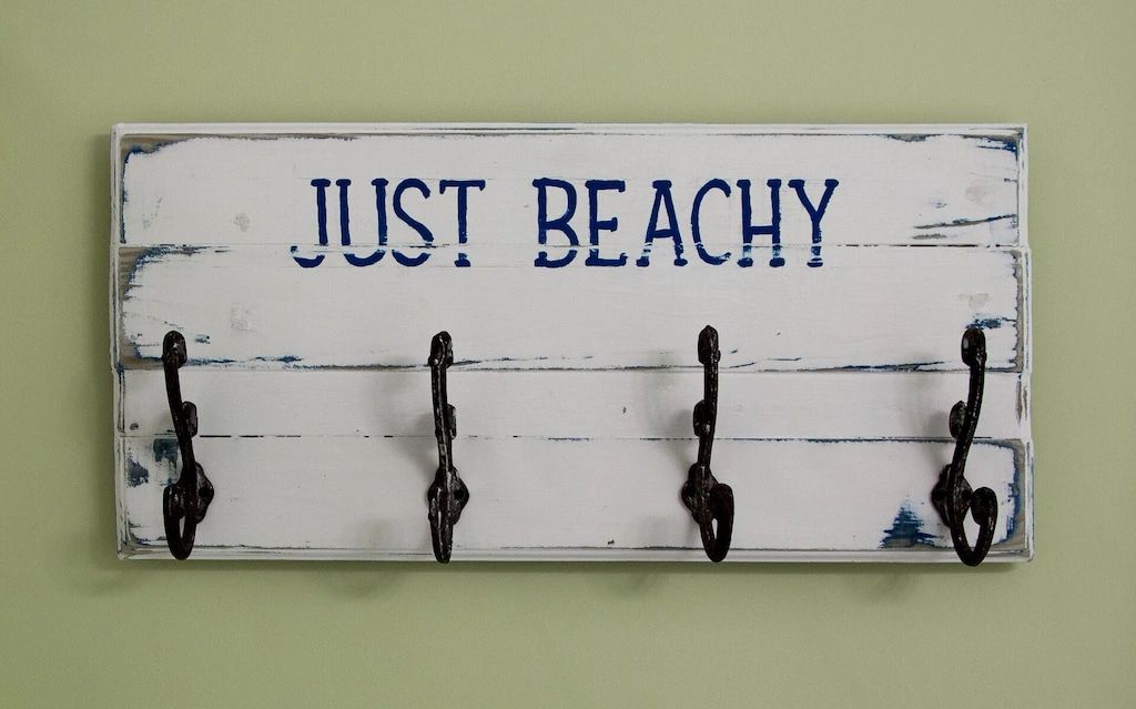 A sign on a wall that says just beachy