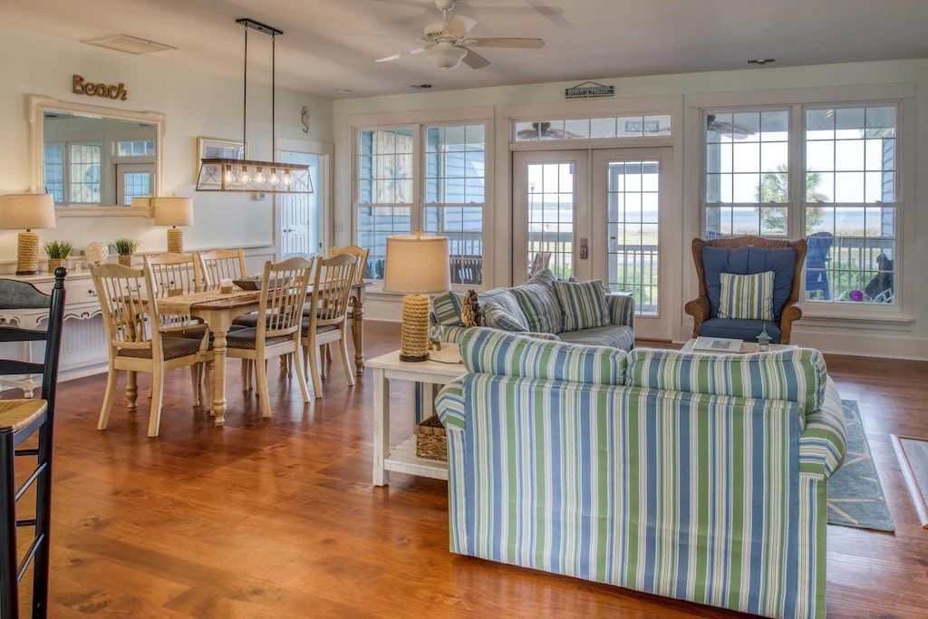 A living room filled with furniture and a dining room.
