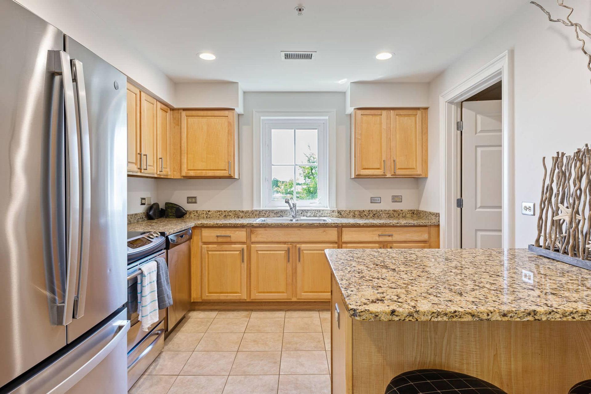 A kitchen with stainless steel appliances and granite counter tops