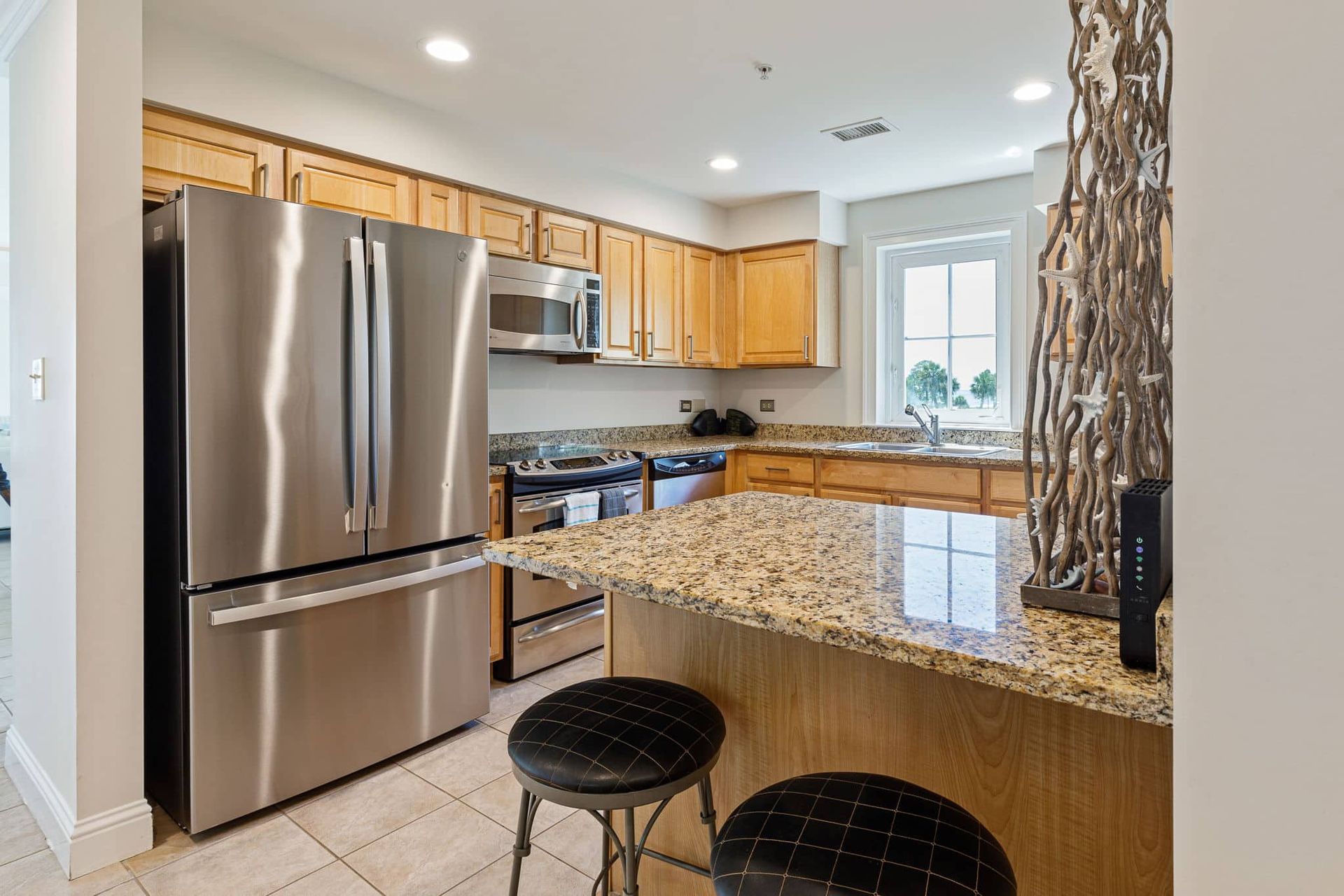 A kitchen with stainless steel appliances and granite counter tops.