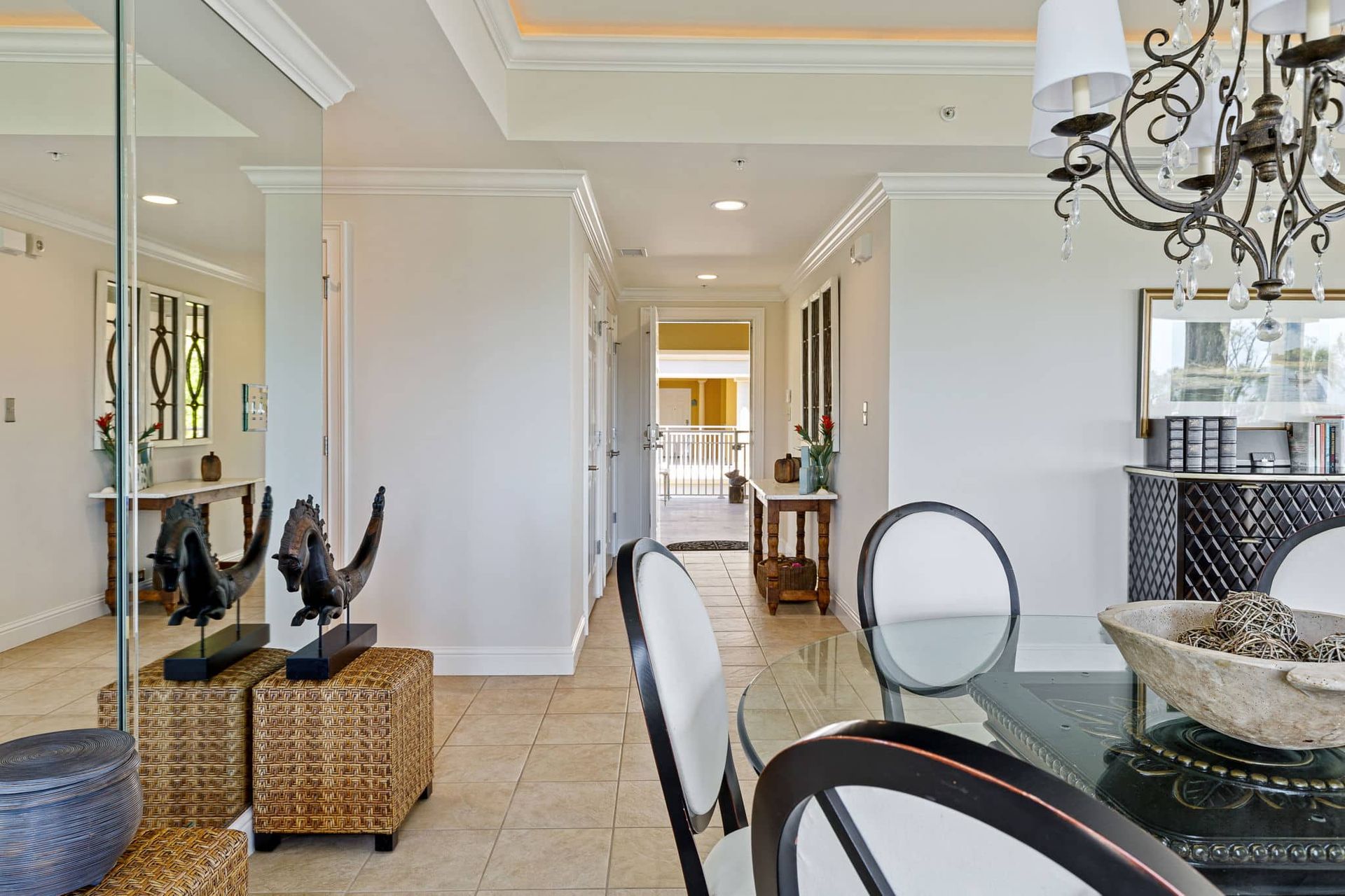 A dining room with a table and chairs and a chandelier