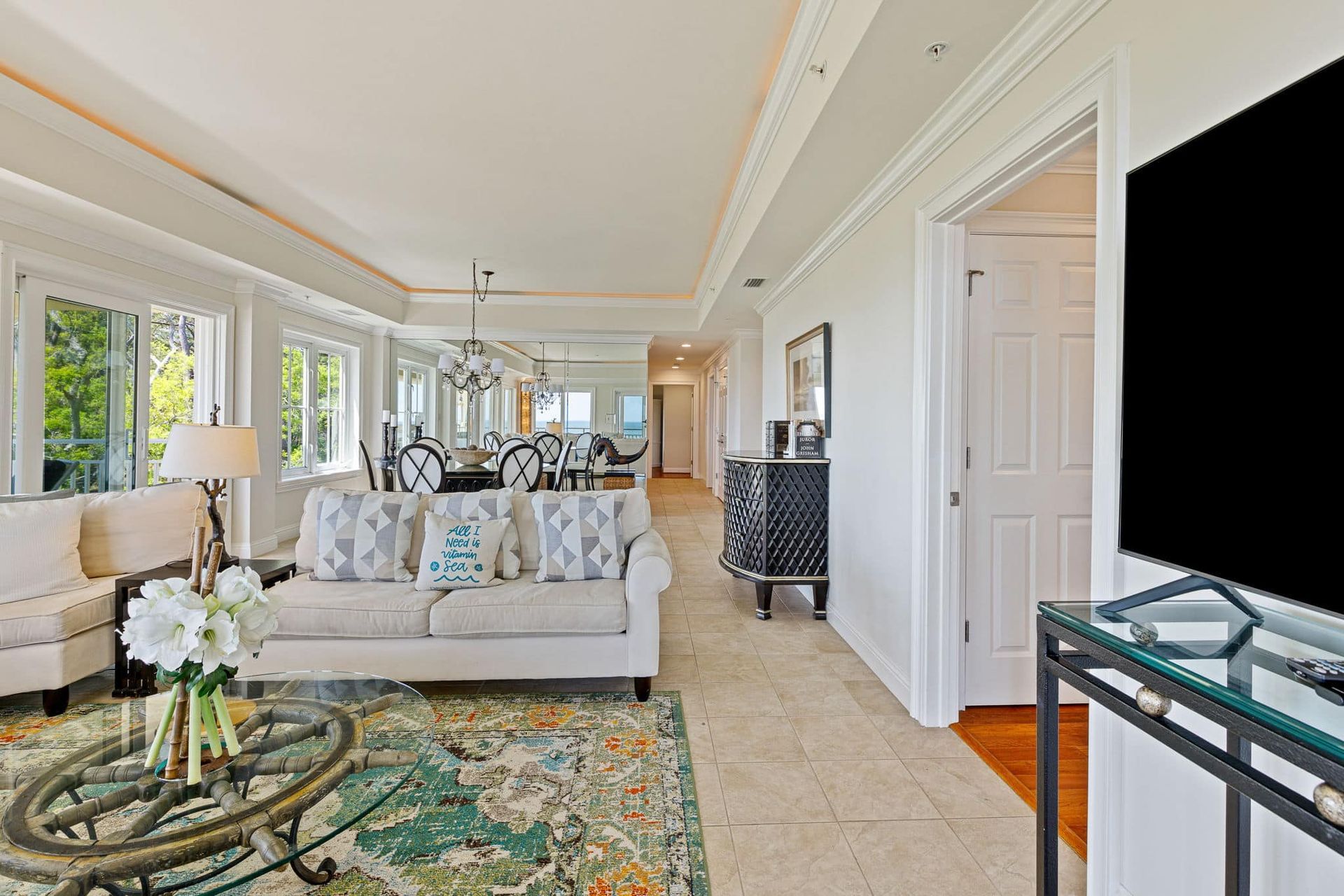 A living room with a couch , coffee table , and television.