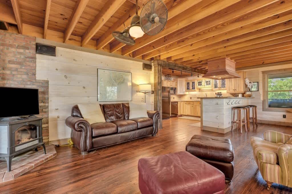 A living room with a large sectional couch and a flat screen tv.