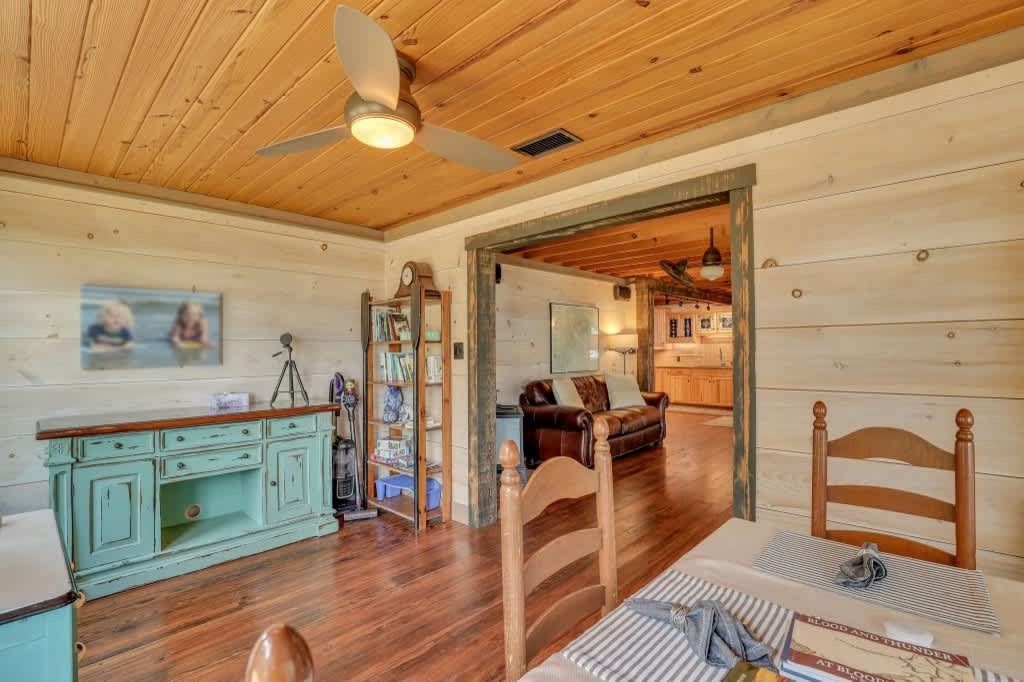 A hallway leading to a bedroom with a walk in shower.
