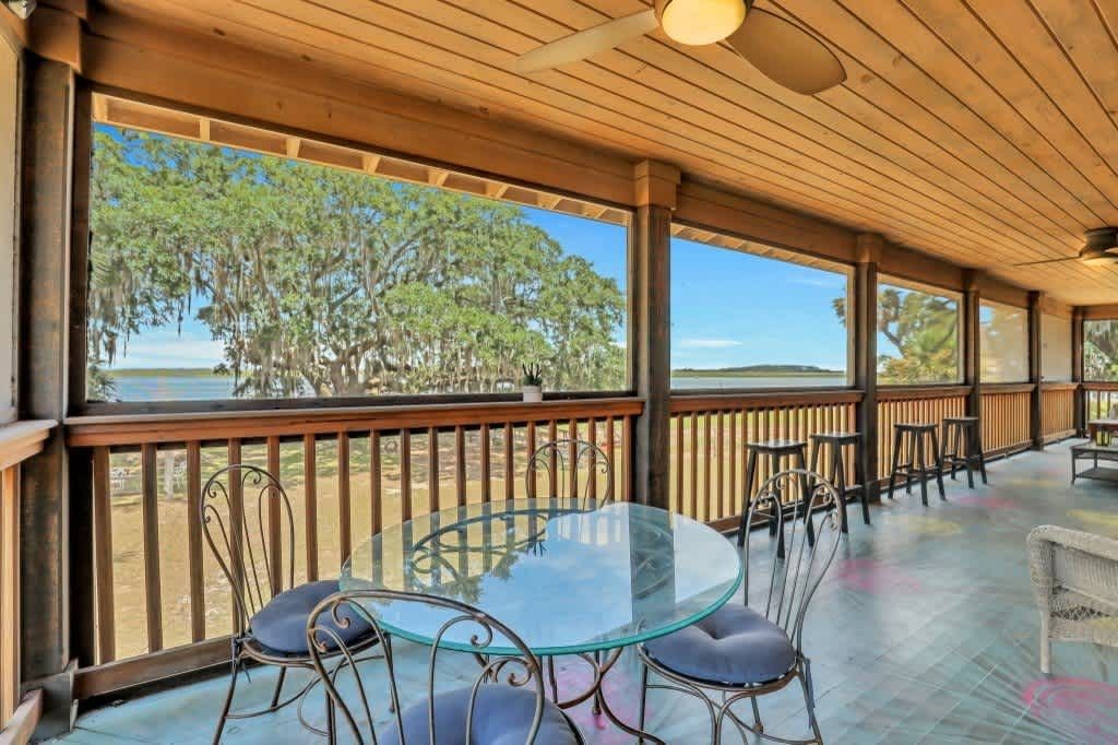 A dining room with a table and chairs and a sign that says beach.