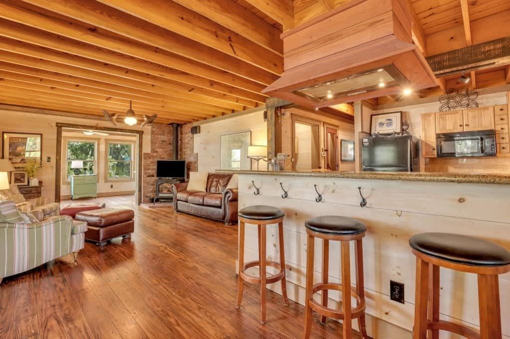 A bedroom with two beds , a dresser , and a ceiling fan.