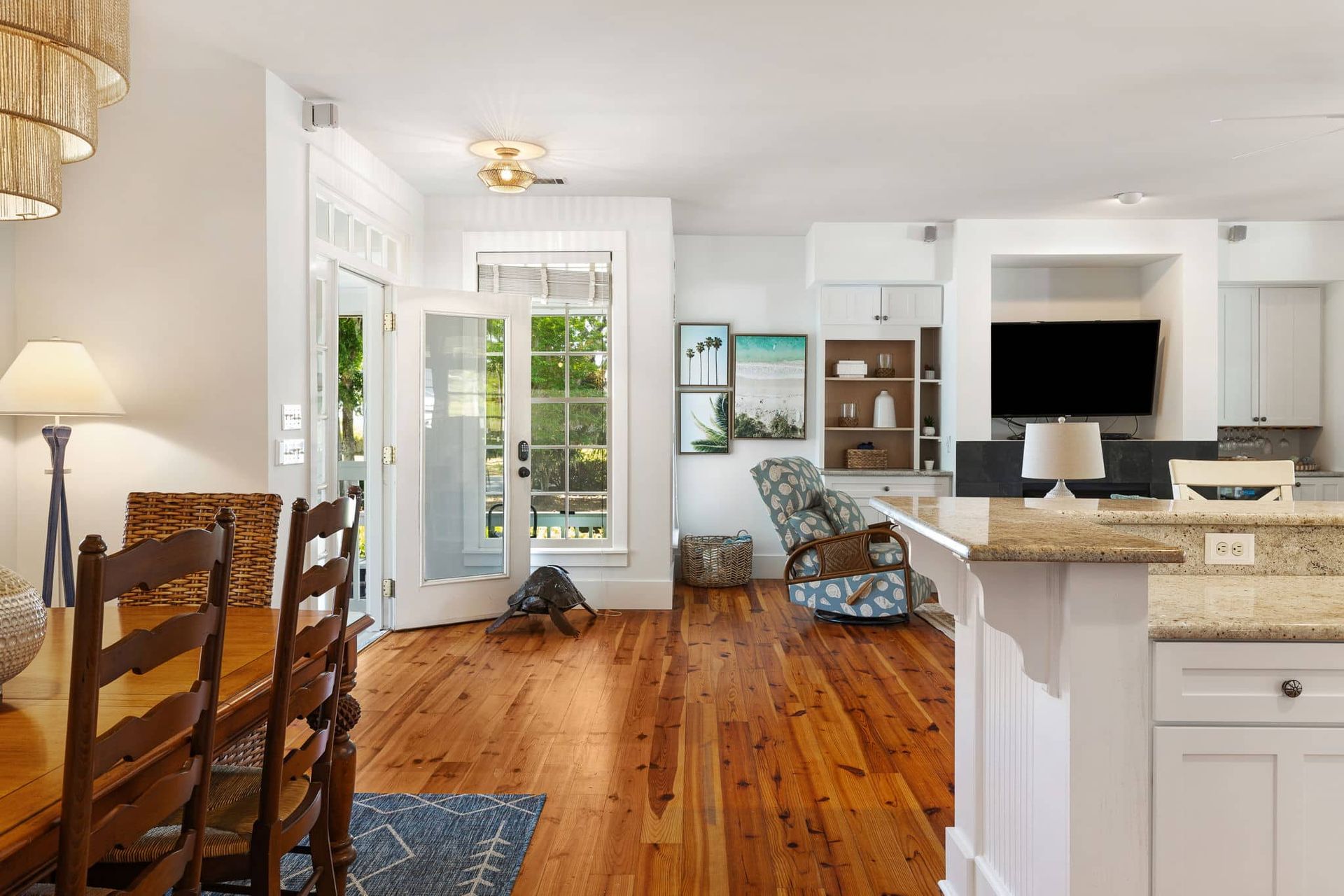 A living room with hardwood floors and a dining table and chairs